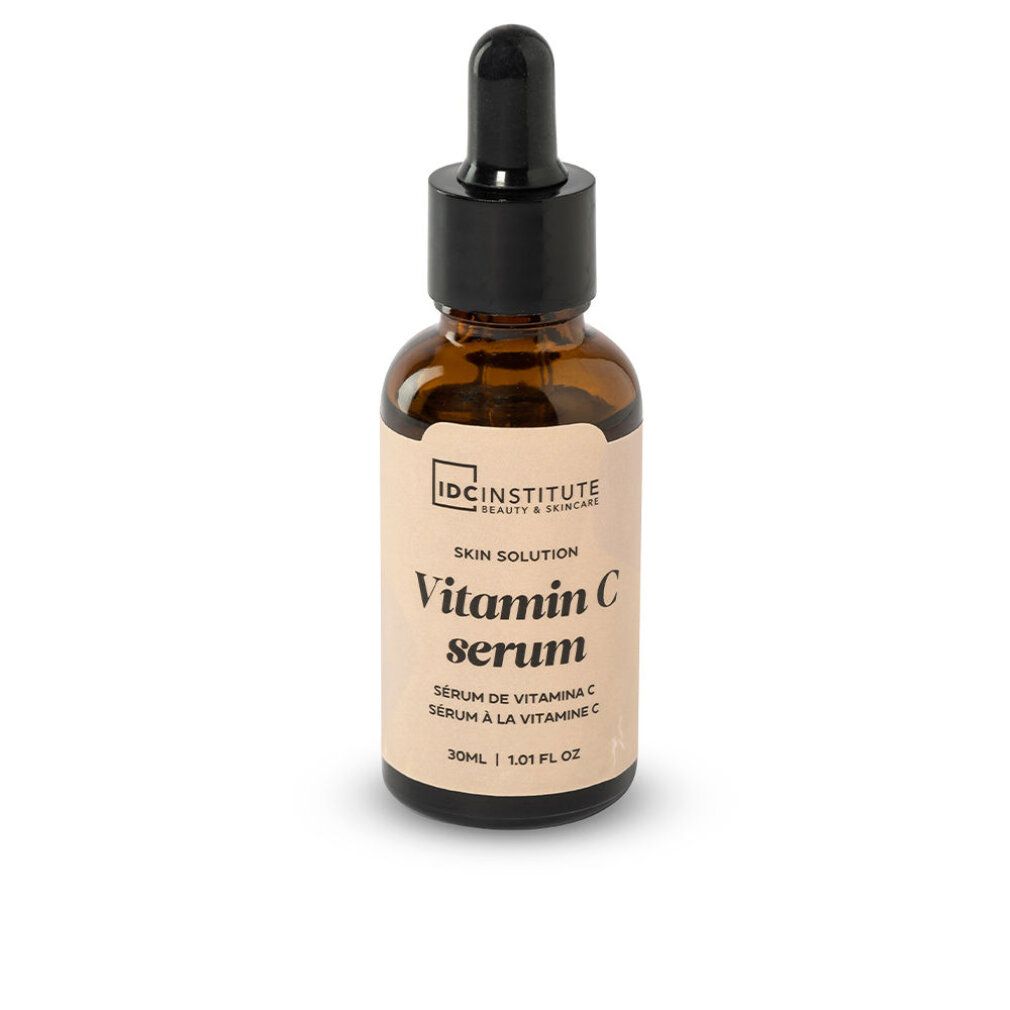 Braune Glasflasche mit schwarzem Deckel und Pipette. Etikett mit "Vitamin C serum" und "IDC INSTITUTE".