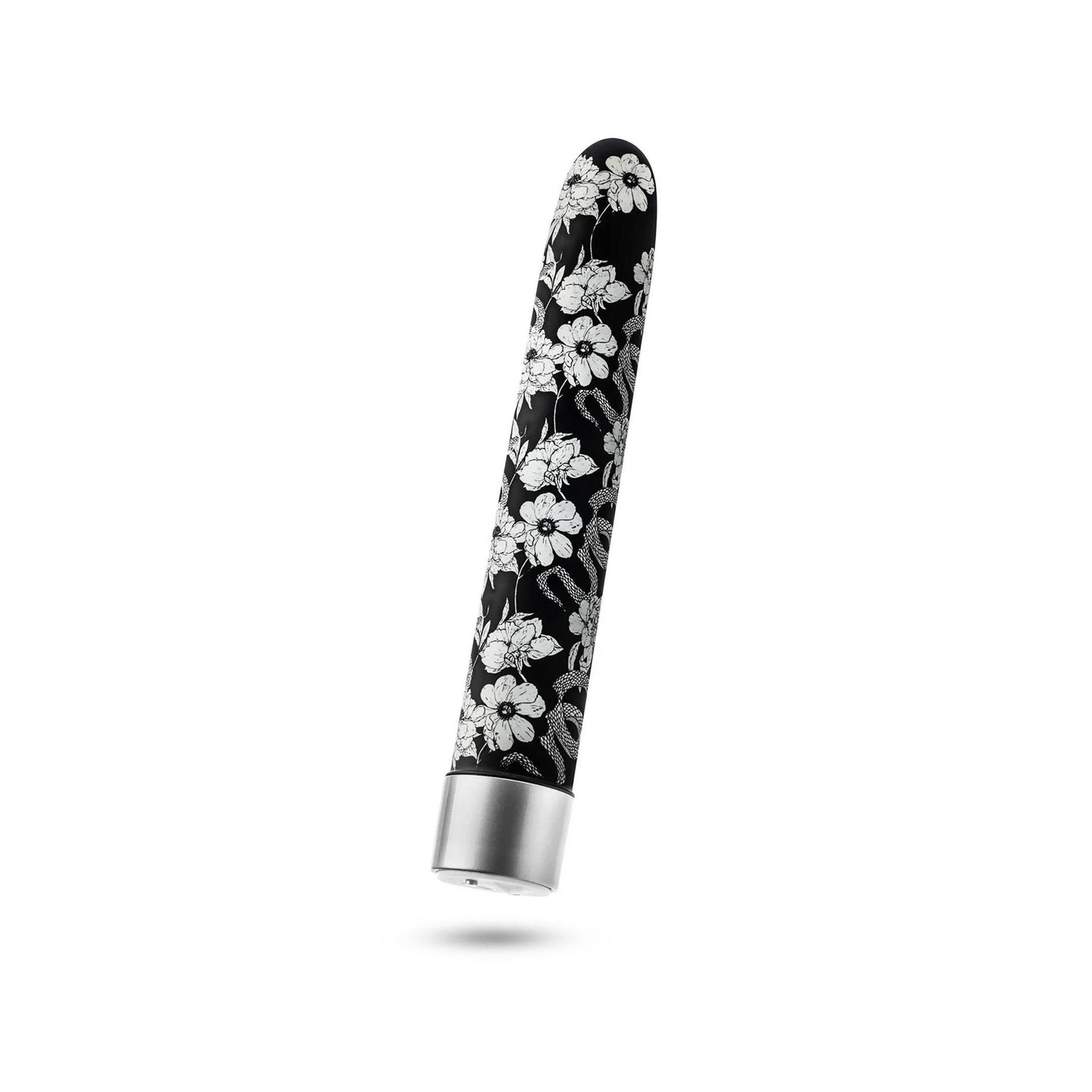Zylindrisches Wellness-Produkt mit Blumenmuster. Schwarzer Hintergrund, silberfarbener Abschluss.