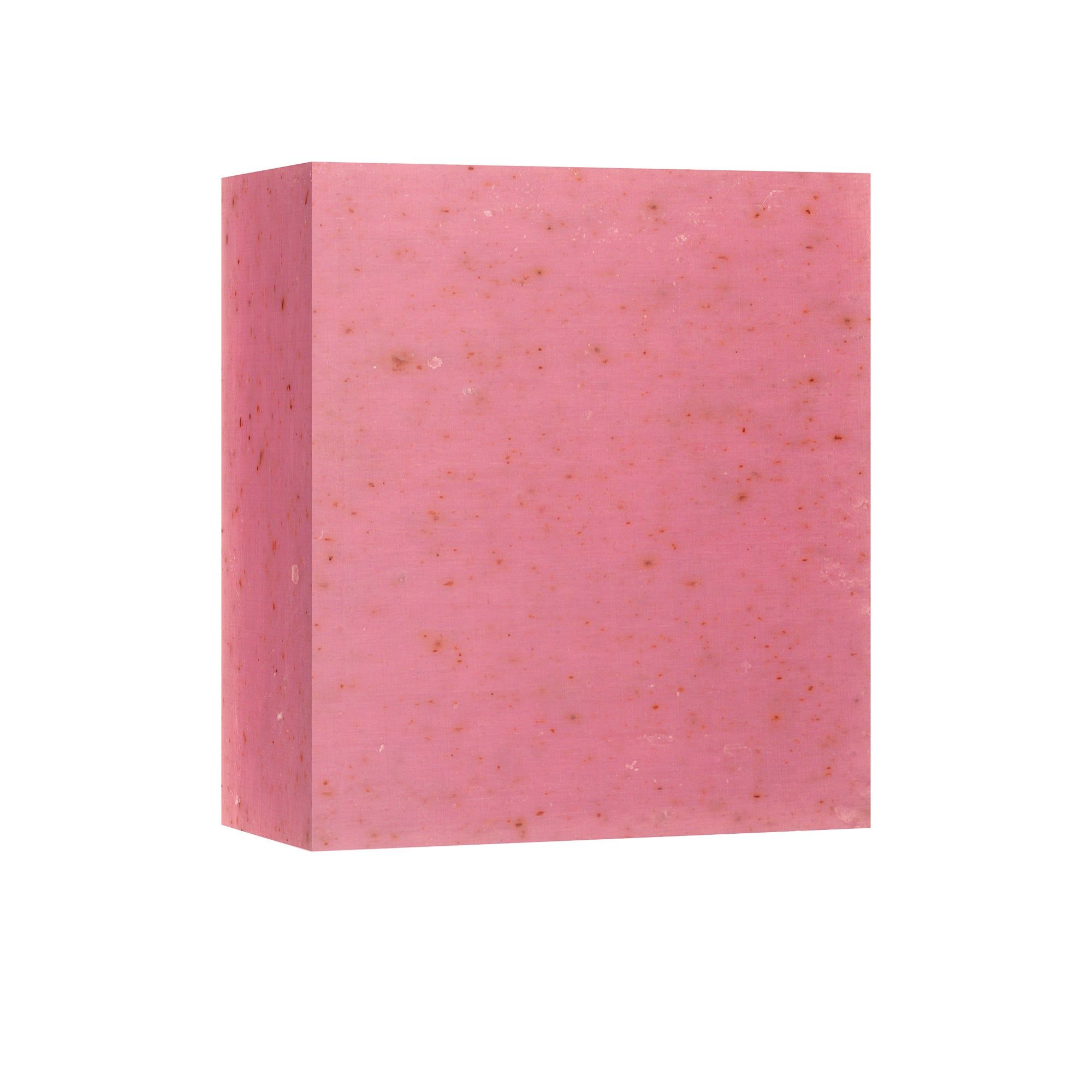 Rosa Blockseife. Eckige Form. Rosa Farbton mit kleinen, dunklen Punkten. Auf weißem Hintergrund.