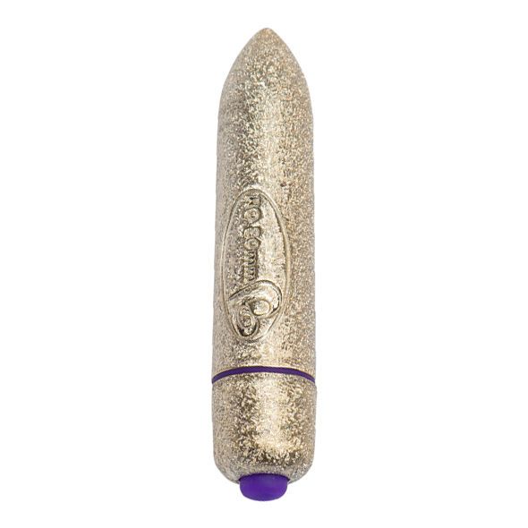 Goldfarbener Bullet-Vibrator mit glitzernder Oberfläche. Zylindrische Form mit abgerundeter Spitze. Lila Akzent.