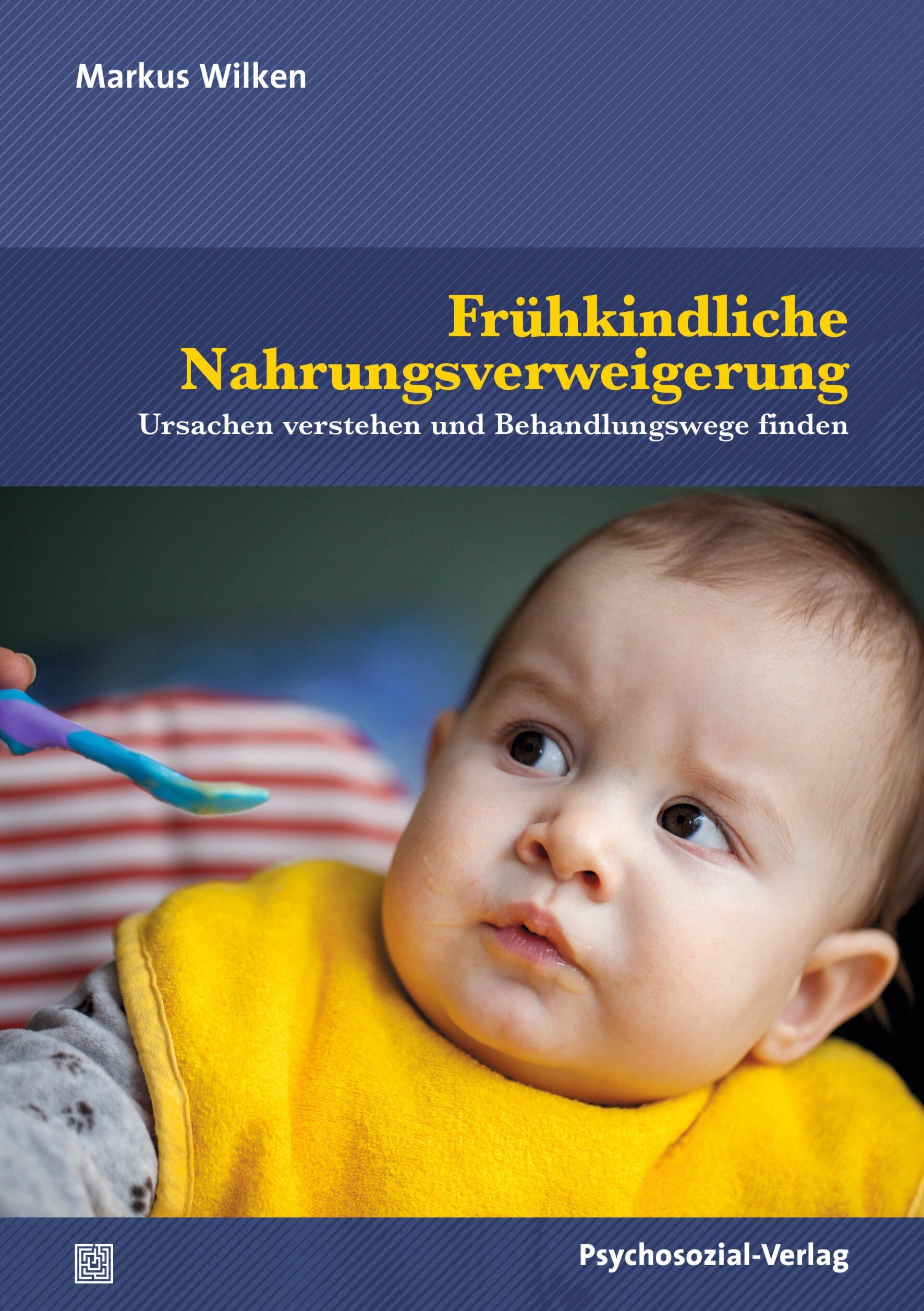 Buchcover: Frühkindliche Nahrungsverweigerung. Titel und Autor Markus Wilken. Baby mit Lätzchen, Löffel im Bild.