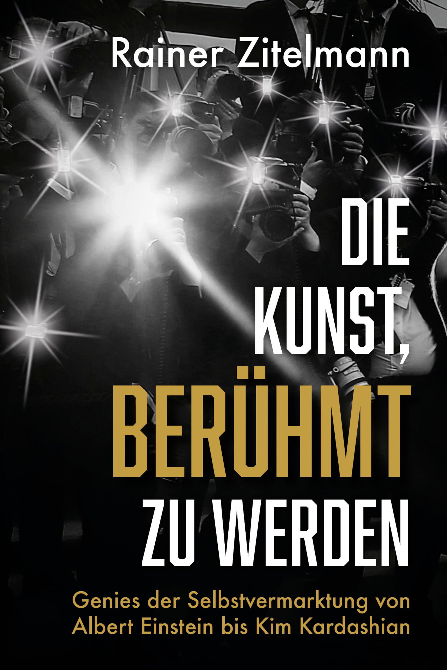 Buchcover: "Die Kunst, berühmt zu werden". Autor: Rainer Zitelmann. Titel in Gold, Hintergrund mit Blitzlichtfotografen.
