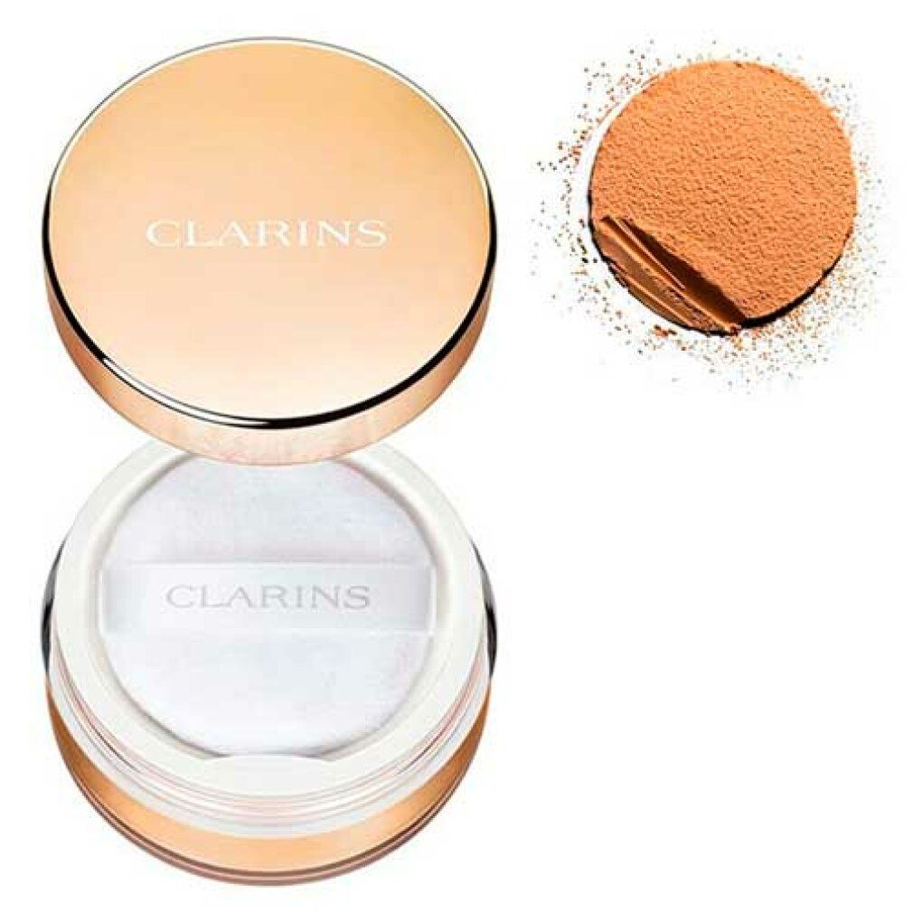 Puderbehälter, geöffnet, daneben Puder. Goldfarbener Deckel mit Schriftzug CLARINS. Puder und Applikator sichtbar.
