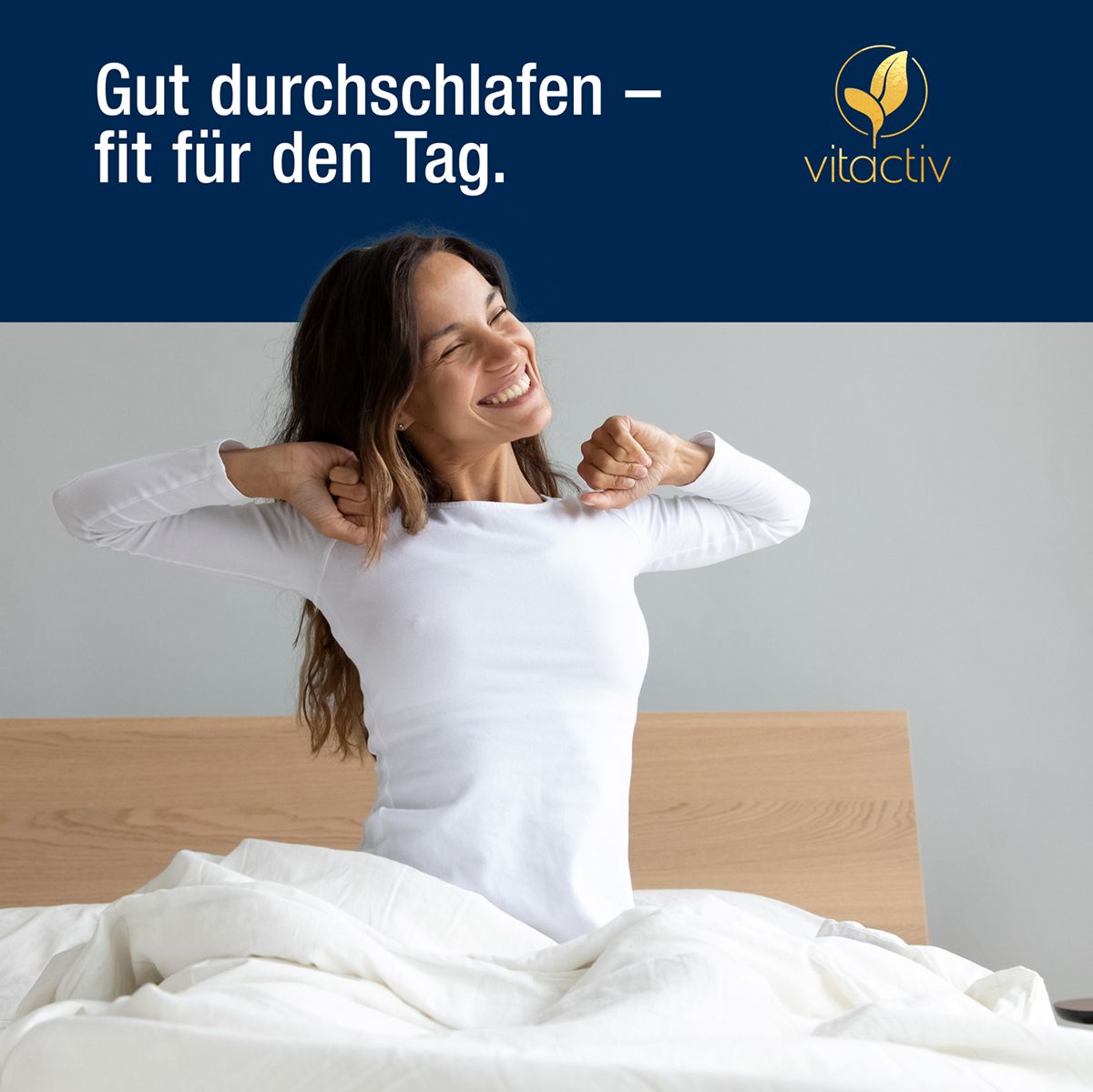 Frau streckt sich lächelnd im Bett, Vitactiv Logo oben rechts.