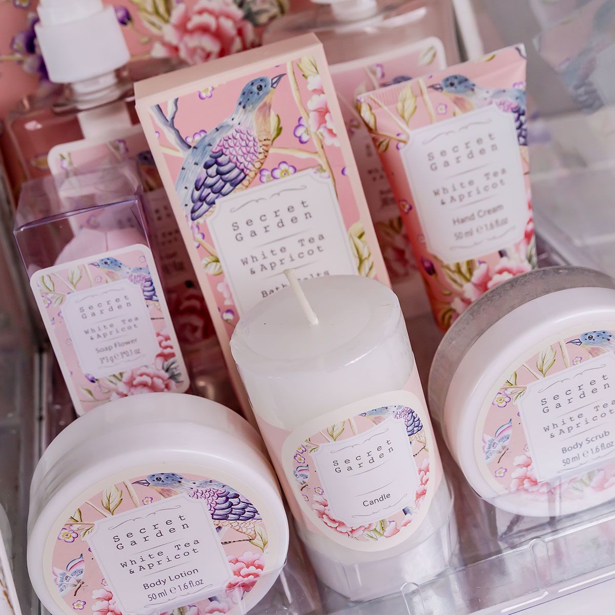 Nahaufnahme von Wellnessprodukten: Lotion, Kerze, Duschgel, Badesalz, Handcreme.