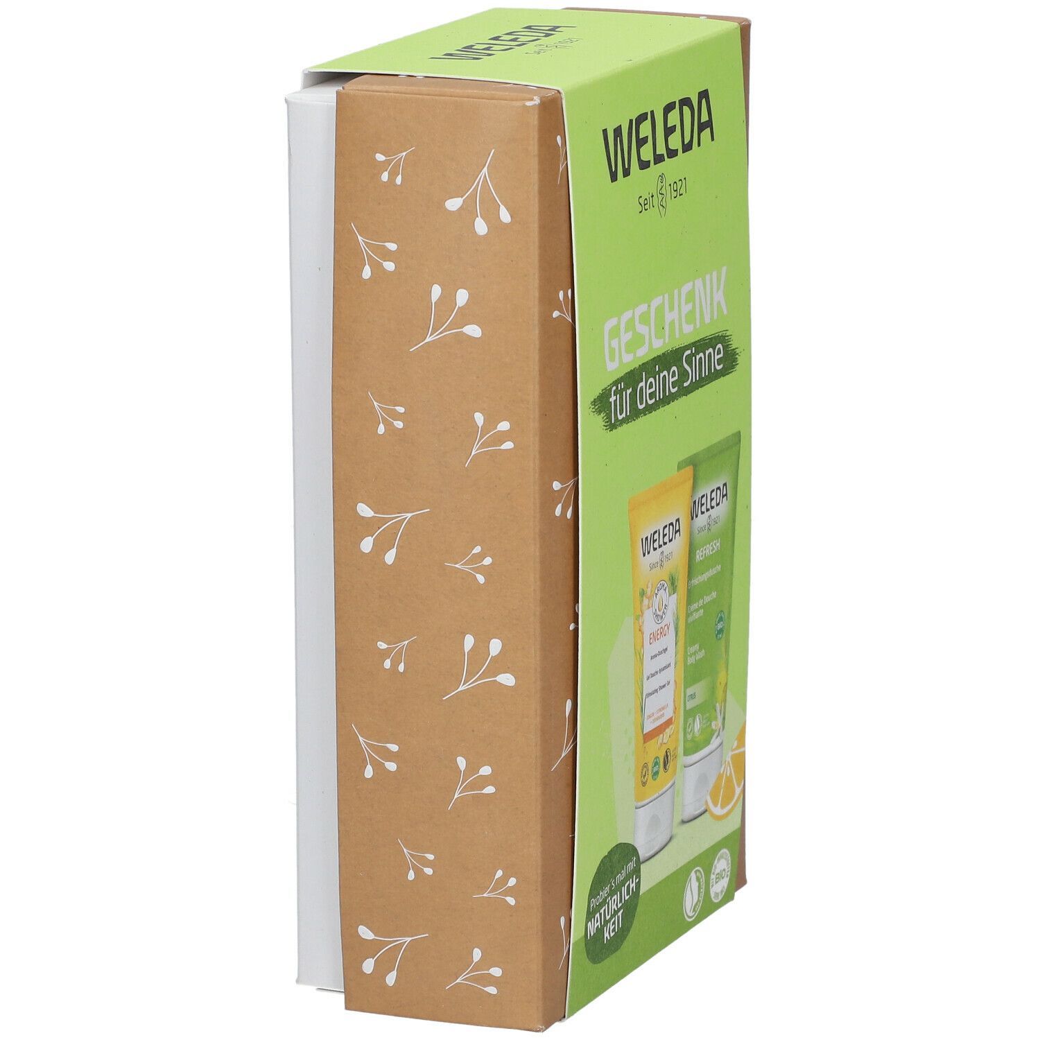 Geschenkset von Weleda. Seitenansicht der Verpackung. Aufschrift: Weleda, Geschenk für deine Sinne. Zwei Tuben sichtbar.