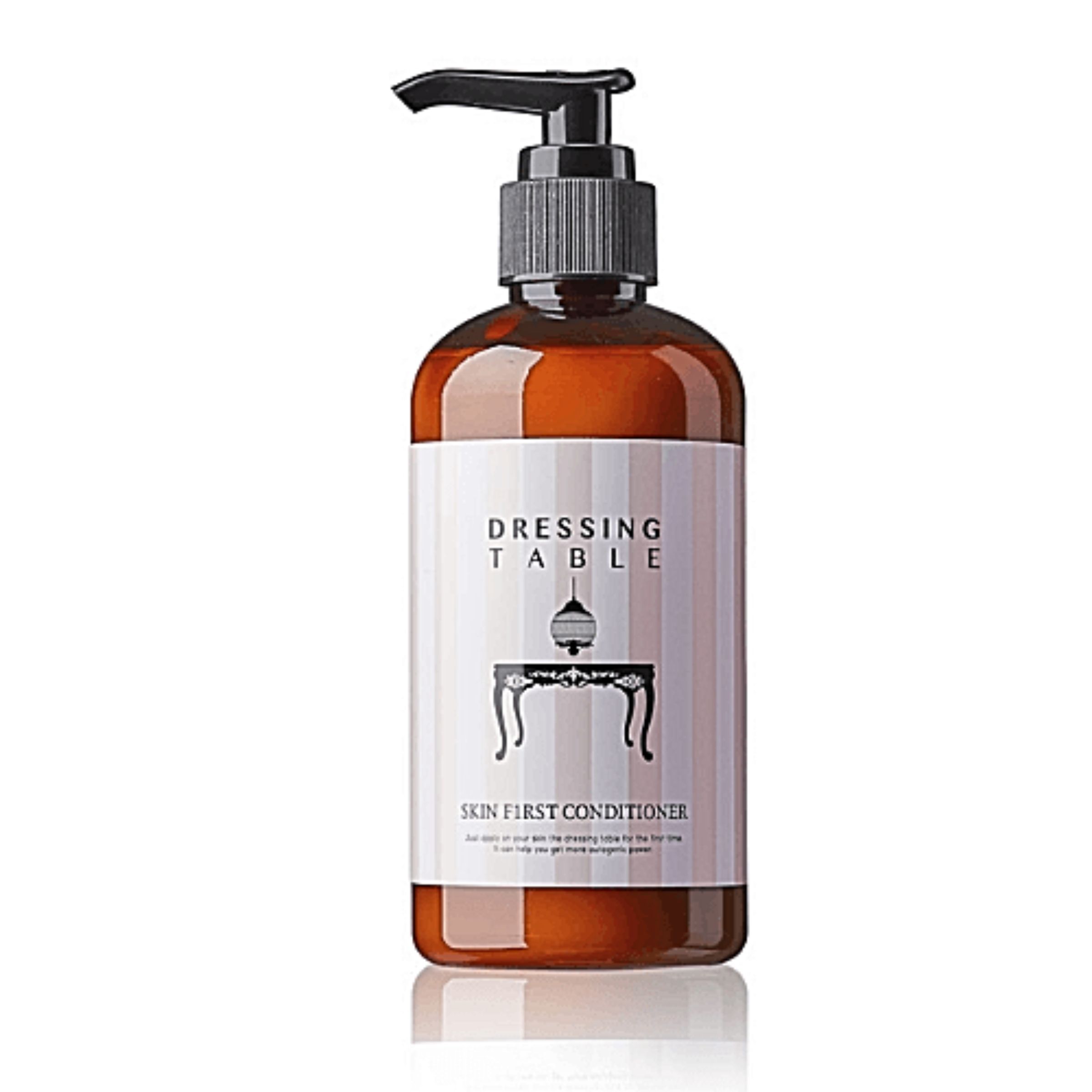Braune Flasche mit schwarzem Pumpkopf. Etikett mit "DRESSING TABLE" und "SKIN FIRST CONDITIONER".