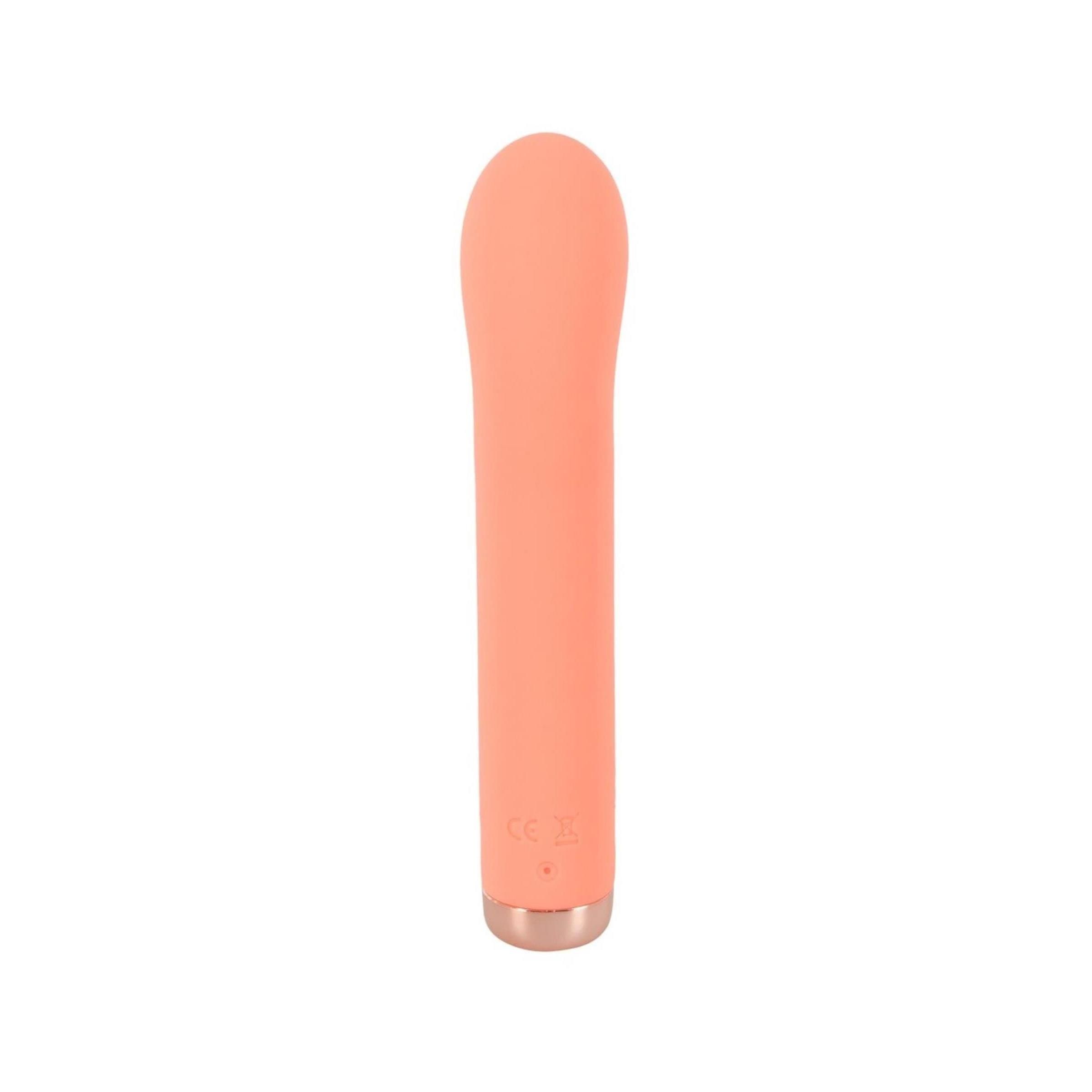 Pfirsichfarbener Vibrator mit abgerundeter Spitze und goldfarbenem Ende.