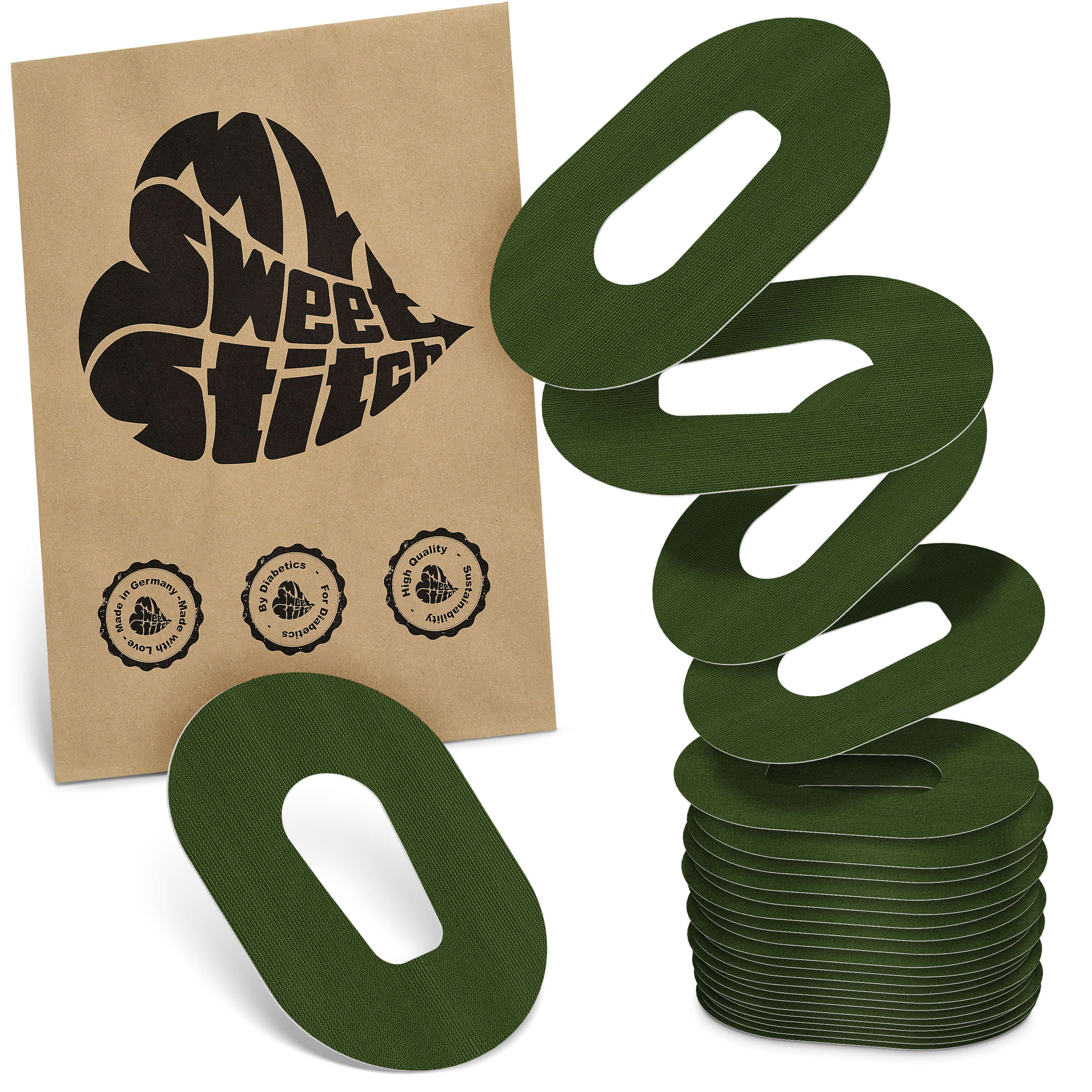 Grüne, ovale Pflaster mit Aussparung. Verpackung mit Logo "MySweetStitch" und Siegeln. Stapel von Pflastern.
