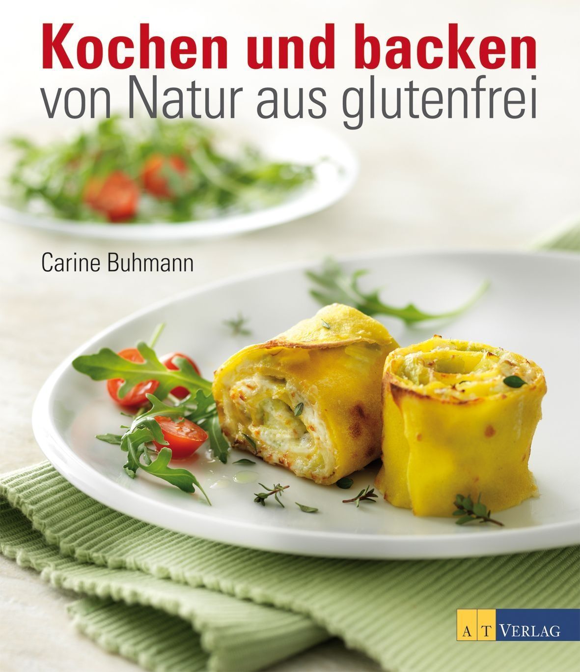 Buchcover: „Kochen und backen – von Natur aus glutenfrei“. Auf einem Teller: Gerollte Speise, Tomaten, Salat. Im Hintergrund: Teller mit Salat.