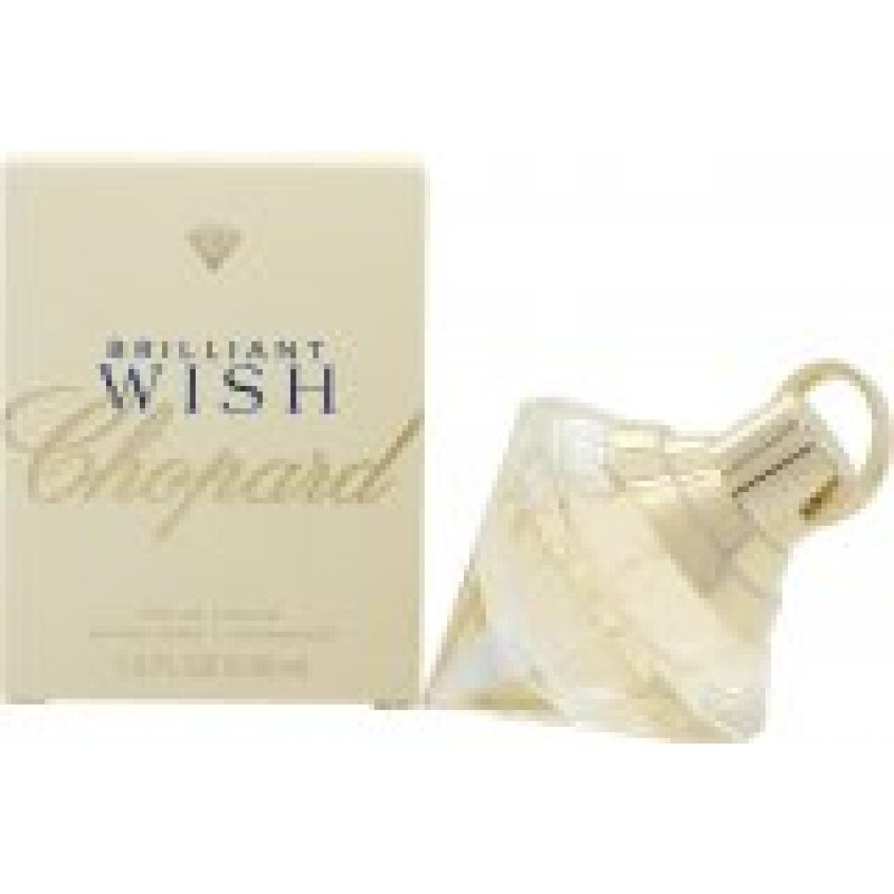 Parfümflakon und Verpackung. Flakon diamantförmig, hellgelb. Verpackung cremefarben mit Schriftzug 'Brilliant Wish Chopard'.
