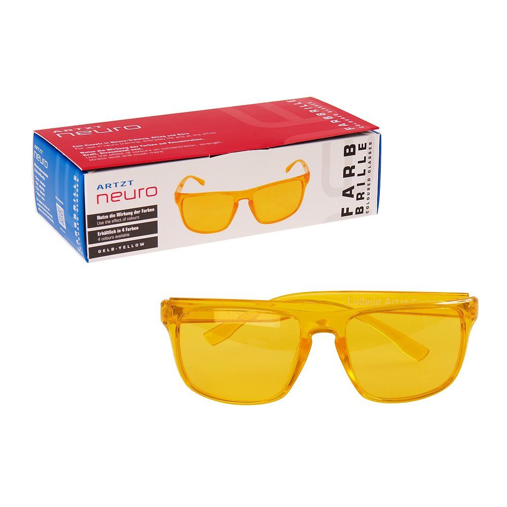 Gelbe Brille und Verpackung. Auf der Verpackung steht "Artzt neuro Farbbrille".