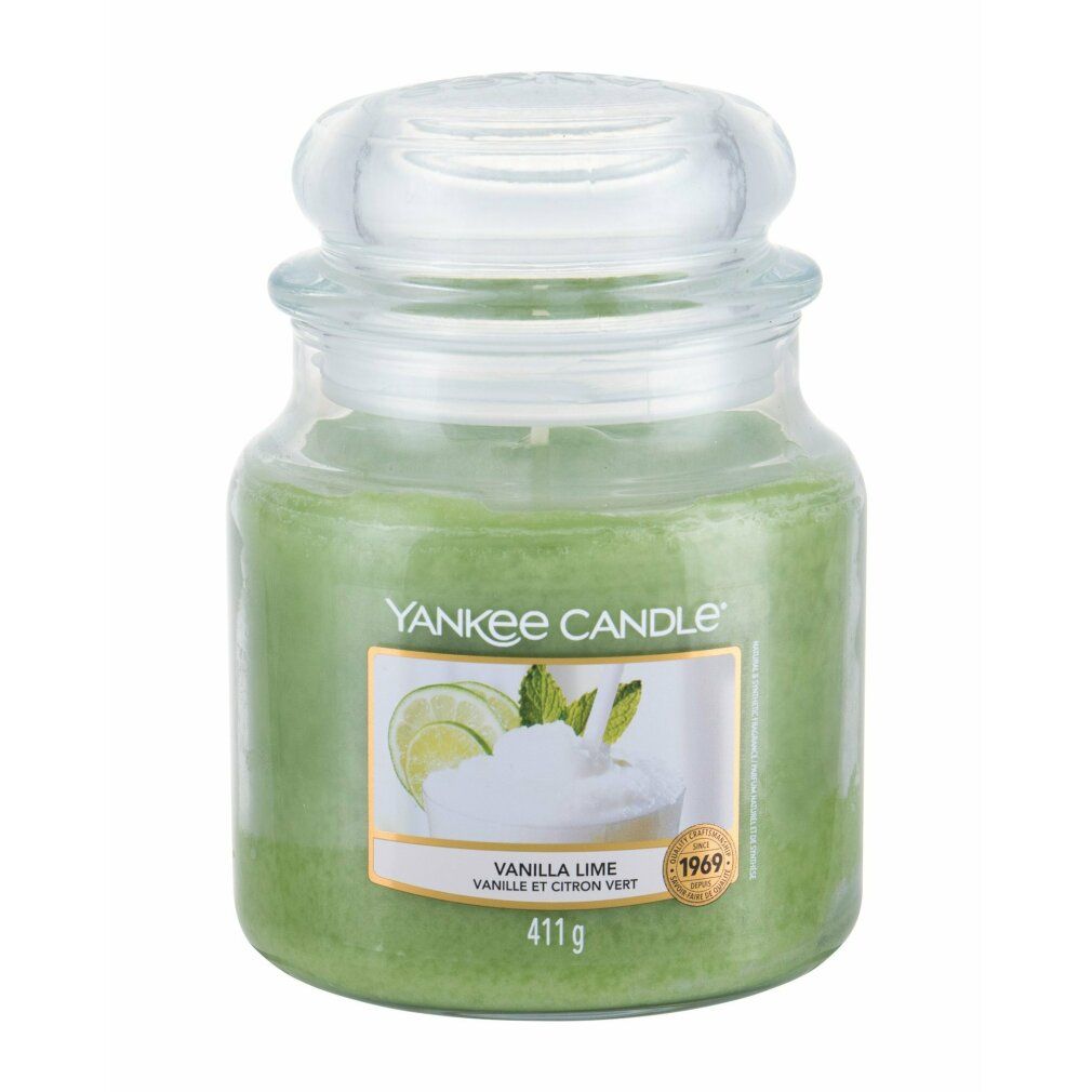 Grüne Kerze im Glas mit Deckel. Etikett mit Limetten- und Minz-Illustration. Text: Vanilla Lime, Yankee Candle.