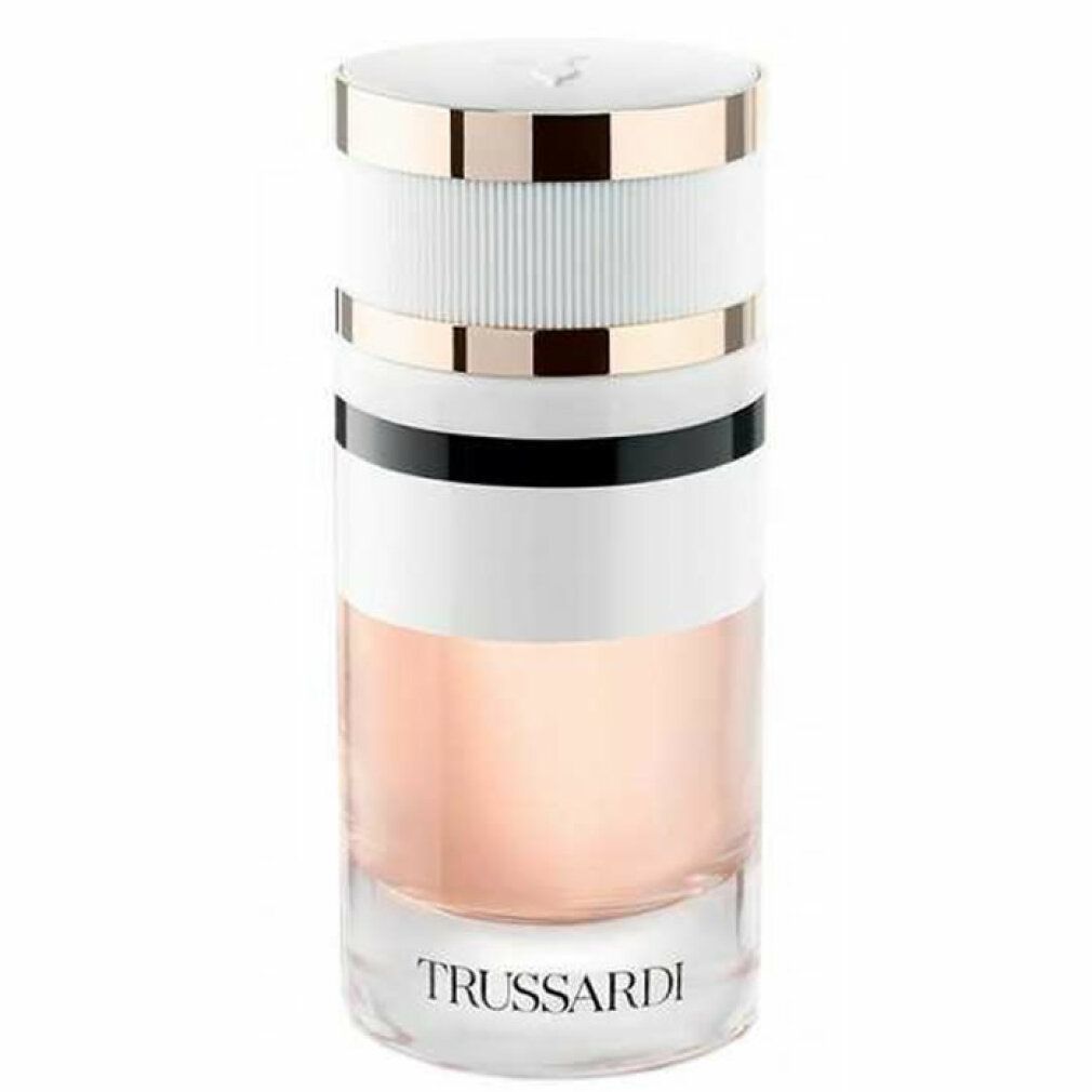 Parfümflakon. Zylindrisch, weiß mit goldenen und schwarzen Akzenten. Aufschrift: TRUSSARDI. Durchsichtiges Glas.