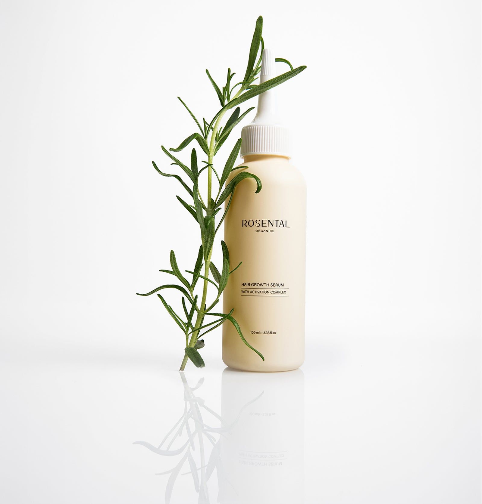 Beige Flasche mit weißem Applikator und grünen Zweigen. Aufschrift: Rosental Organics, Hair Growth Serum.