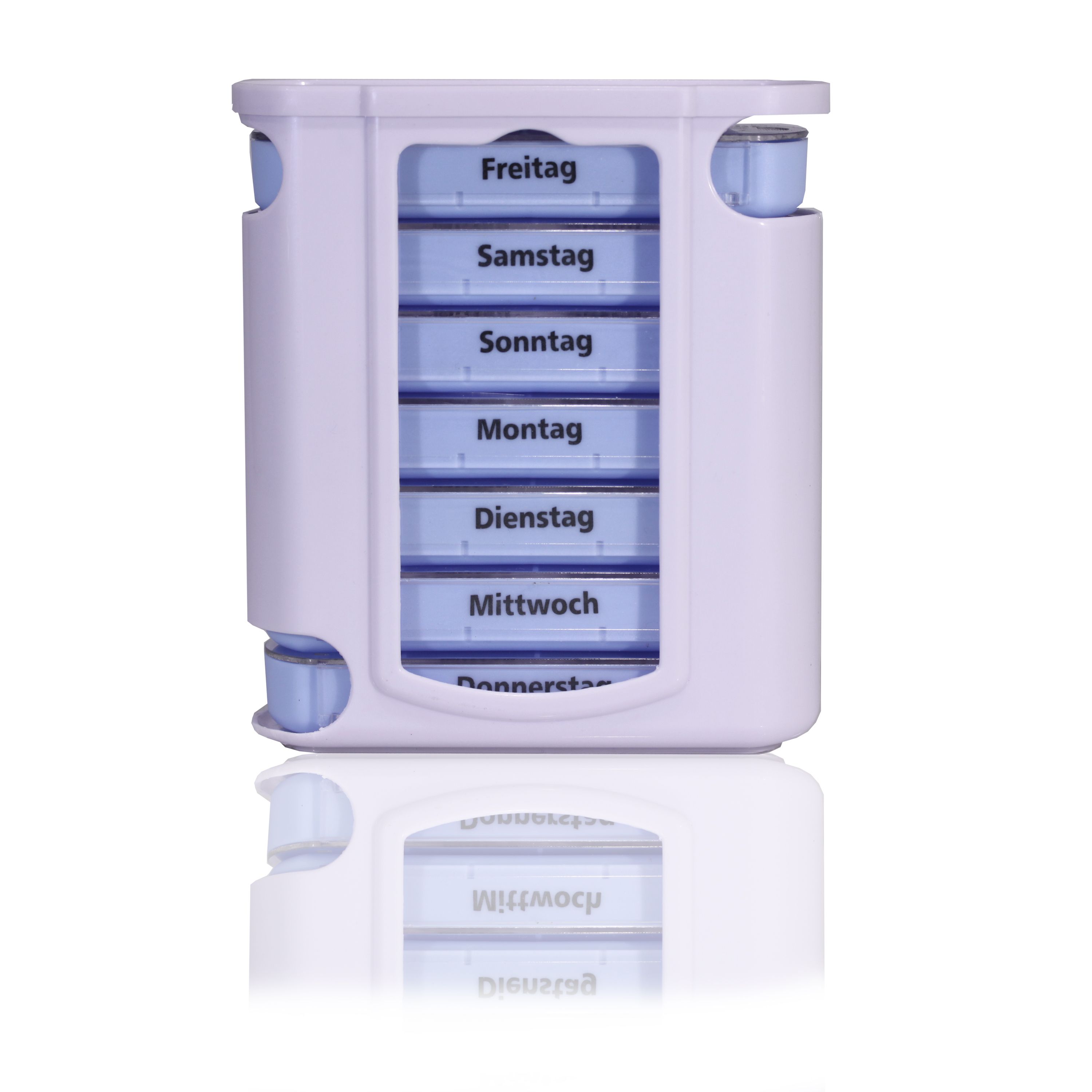 Pillendose mit sieben Fächern, beschriftet mit Wochentagen. Weiß-lila Kunststoff. Rechteckige Form mit abgerundeten Ecken.