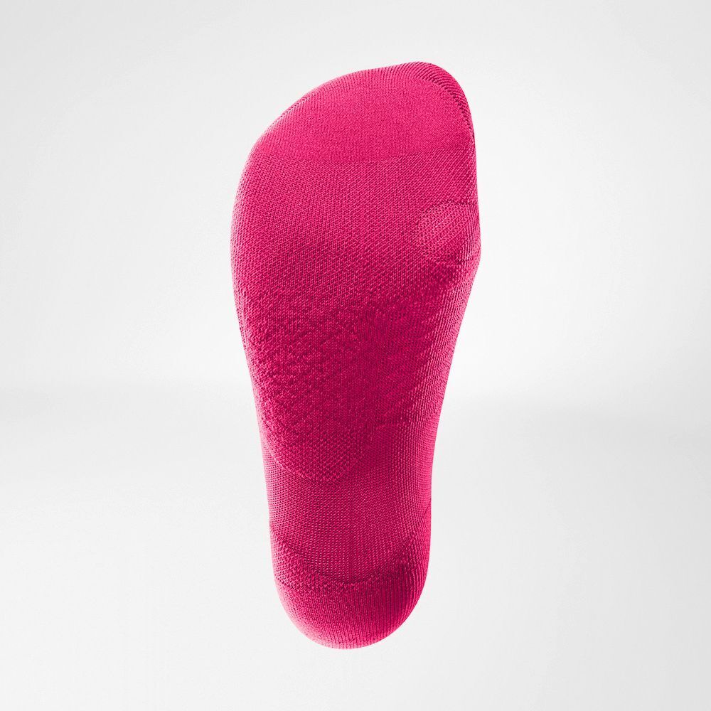 Unterseite einer pinken Kompressionssocke mit sichtbarer Textur und Fersenverstärkung.