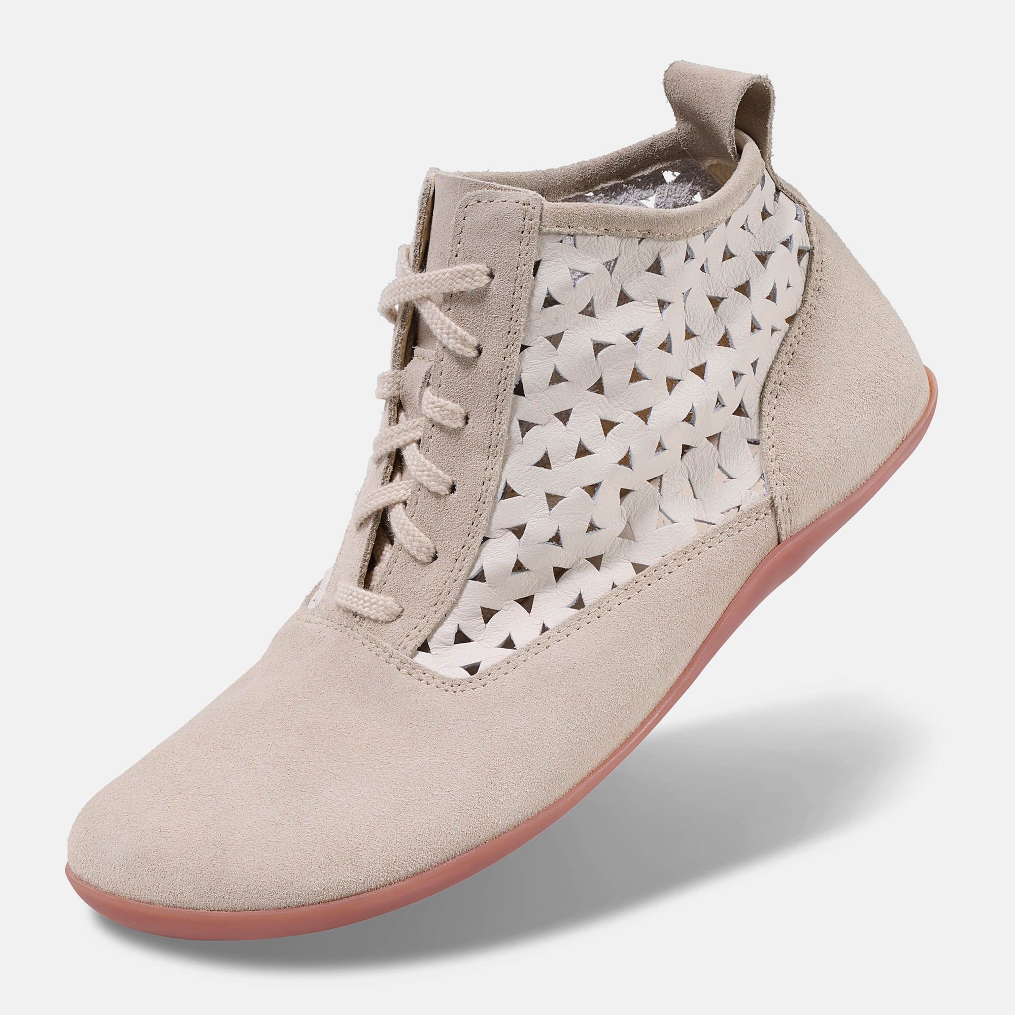 Beige Stiefelette mit Schnürung und Dreiecksmuster. Breite Passform. Rote Sohle. Wildleder. Seitenansicht.