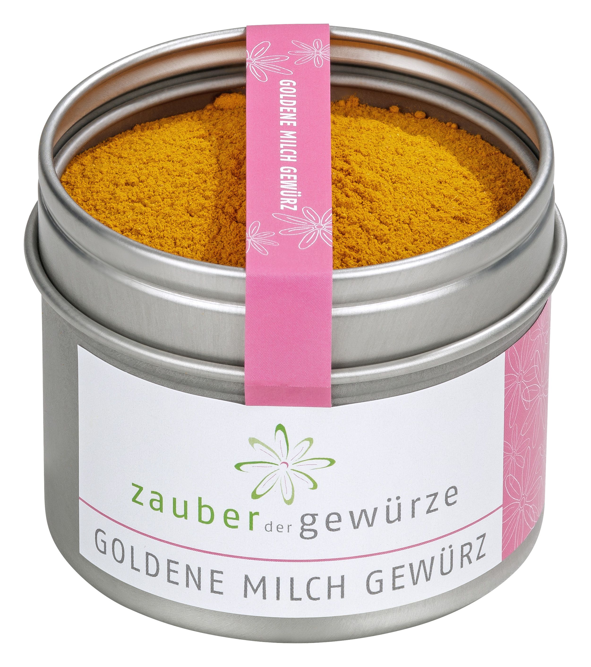 Runde Dose mit goldenem Gewürz. Rosa Etikett mit Schriftzug 'Goldene Milch Gewürz'. Marke 'Zauber der Gewürze'.