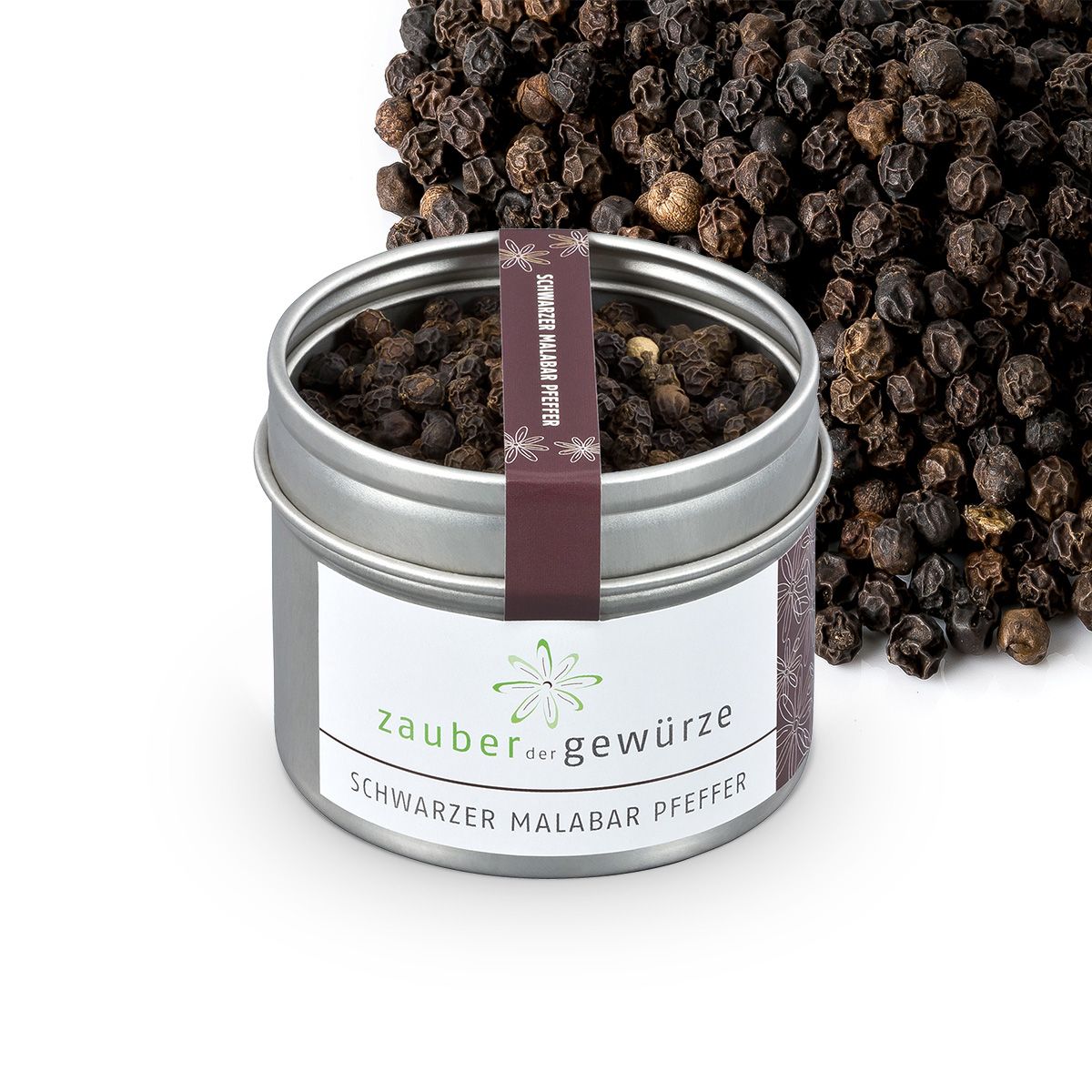 Dose mit schwarzem Malabar-Pfeffer. Aufschrift: Zauber der Gewürze, Schwarzer Malabar Pfeffer. Pfefferkörner daneben.