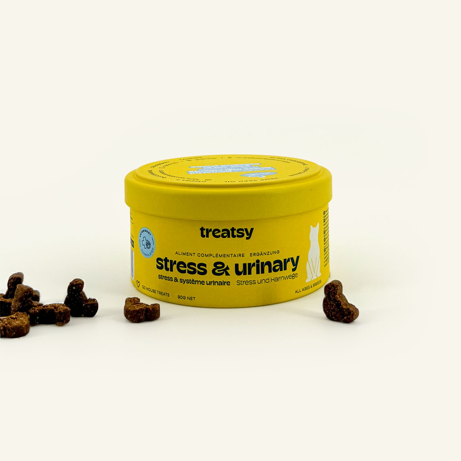 Gelbe Dose mit "treatsy stress & urinary". Braune, mausförmige Snacks liegen daneben.