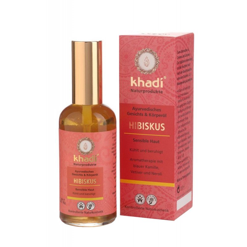 Gesichts- und Körperöl mit roter Verpackung. Flasche mit goldfarbenem Deckel. Aufschrift: Khadi, Hibiskus.