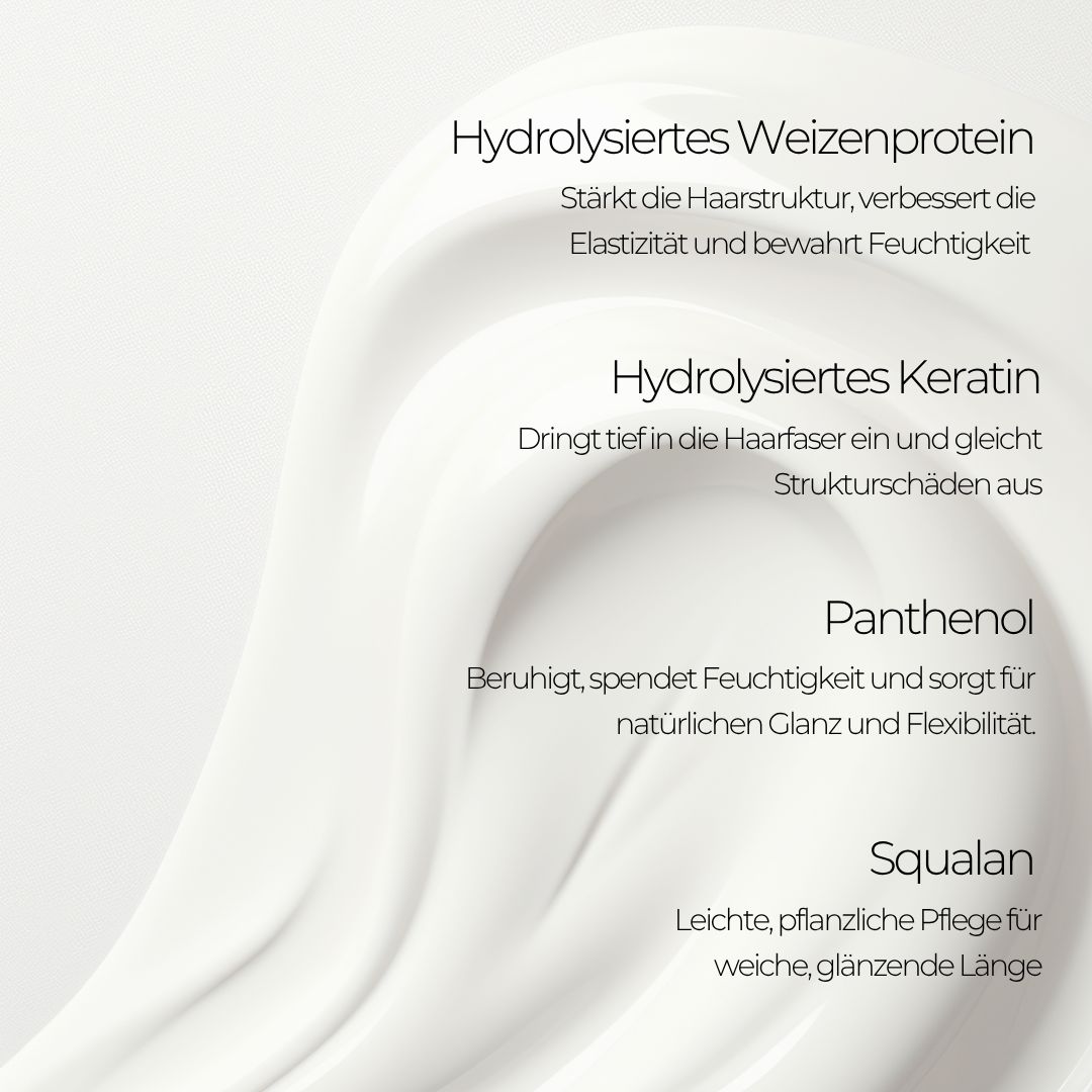 Nahaufnahme von weißer Creme mit Text: Hydrolysiertes Weizenprotein, Keratin, Panthenol, Squalane.