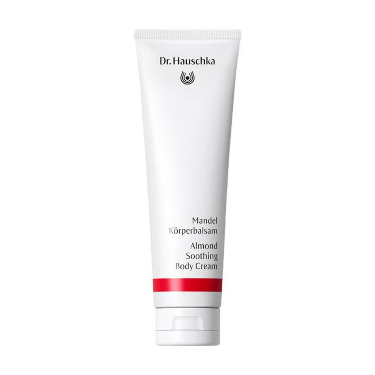 Weiße Tube mit rotem Streifen. Aufschrift: Dr. Hauschka, Mandel Körperbalsam, Almond Soothing Body Cream.