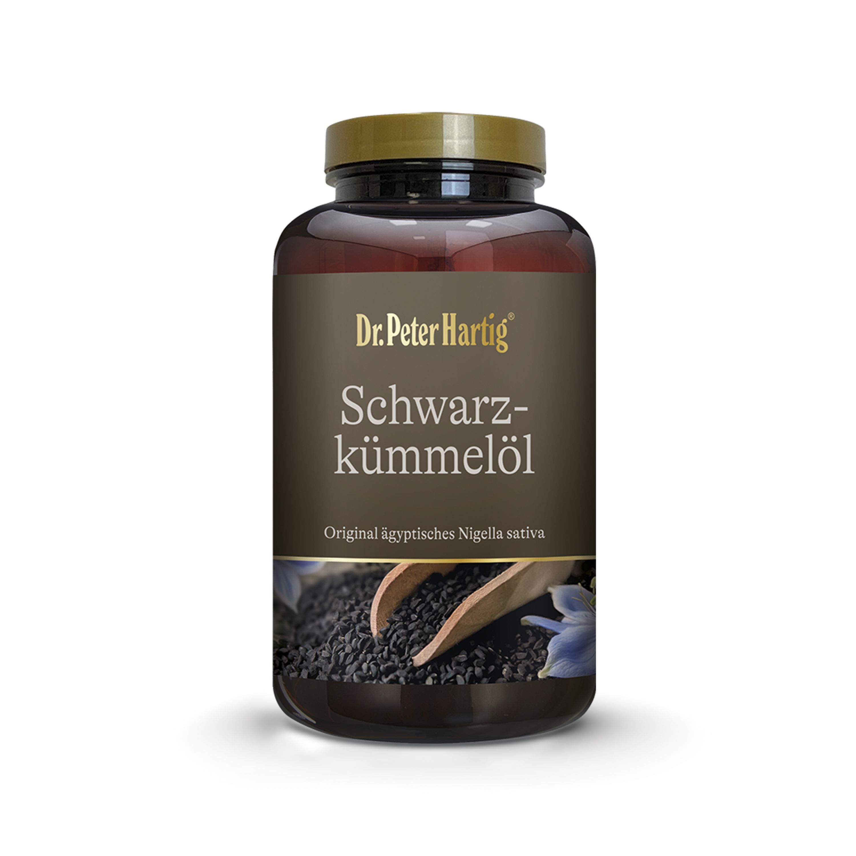 Braune Flasche mit goldfarbenem Deckel. Aufschrift: Dr. Peter Hartig Schwarzkümmelöl. Schwarze Samen und Holzschaufel.