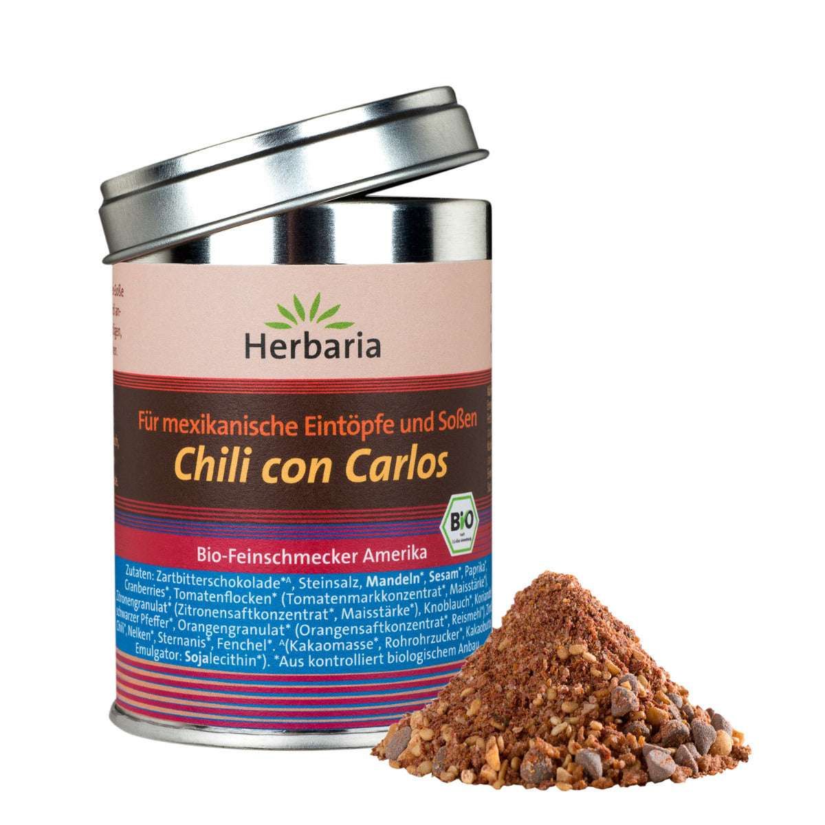 Gewürzmischung in Dose mit offenem Deckel. Daneben ein Haufen Gewürze. Aufschrift: Chili con Carlos, Bio.