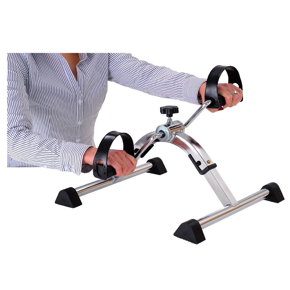 Person hält Pedaltrainer-Griffe. Metallrahmen, schwarze Pedale und Fußstützen. Einstellbarer Widerstand.