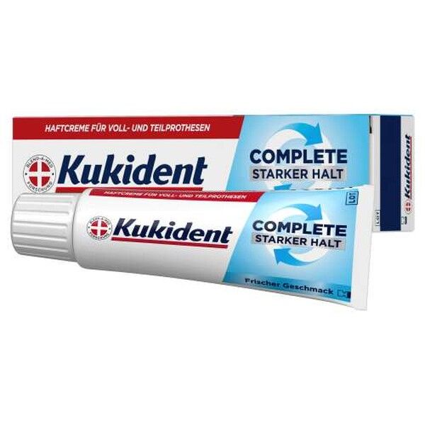 Kukident Haftcreme Complete Starker Halt Tube und Verpackung, weiß, rot und blau.