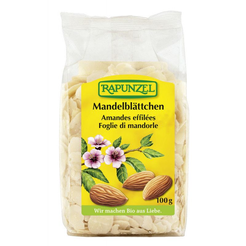Sacchetto trasparente con scaglie di mandorle. Etichetta gialla con "RAPUNZEL" e "Mandelblättchen". Immagini di mandorle e fiori.