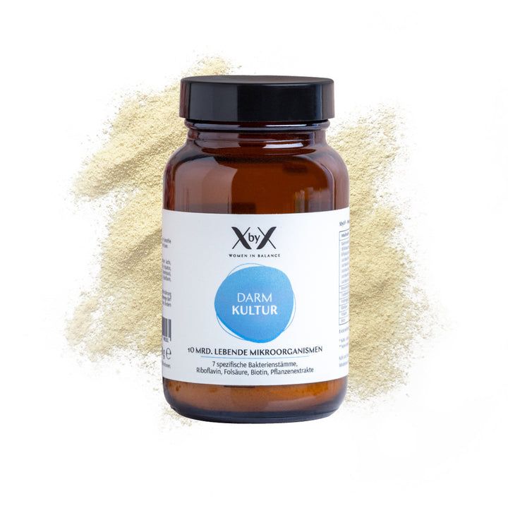 Braune Glasflasche mit schwarzem Deckel. Etikett mit Produktinformationen. Pulver im Hintergrund.