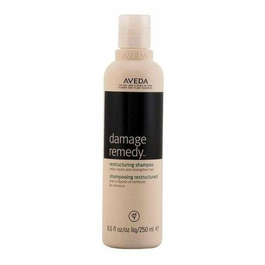 Beige Shampoo-Flasche mit schwarzem Etikett. Aufschrift: Aveda, Damage Remedy, Restructuring Shampoo. 250 ml.