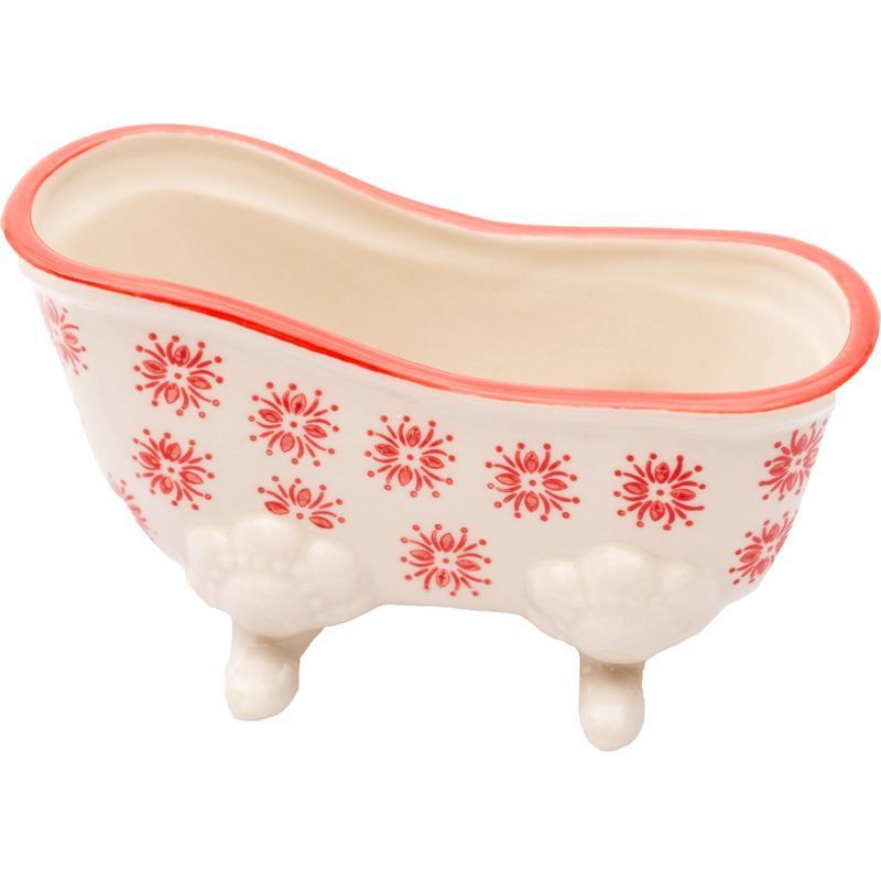 Kleine, rot umrandete Badewanne aus Keramik. Sie hat rote Blumenmuster und steht auf drei Füßen.