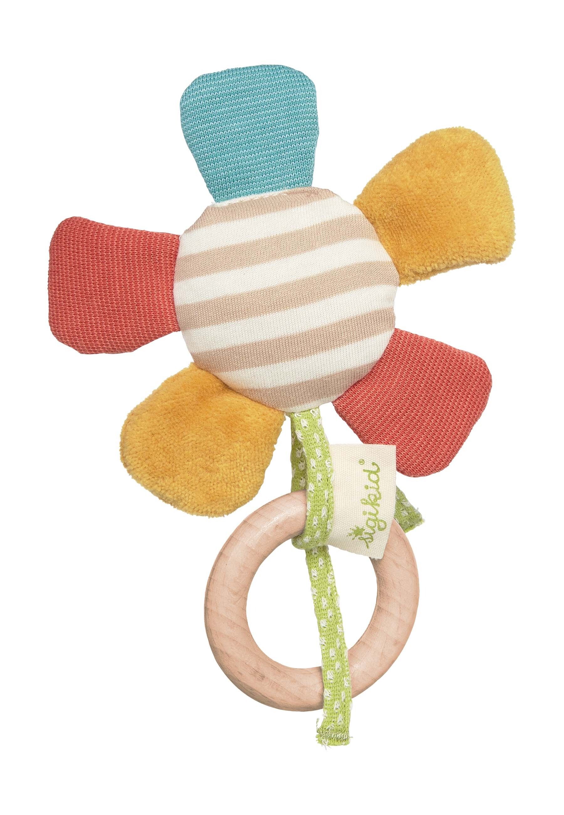 Blumenförmiger Greifling mit Holzring. Mehrfarbige Blütenblätter, gestreifte Mitte, Holzring. Grün-weißes Band mit Logo.