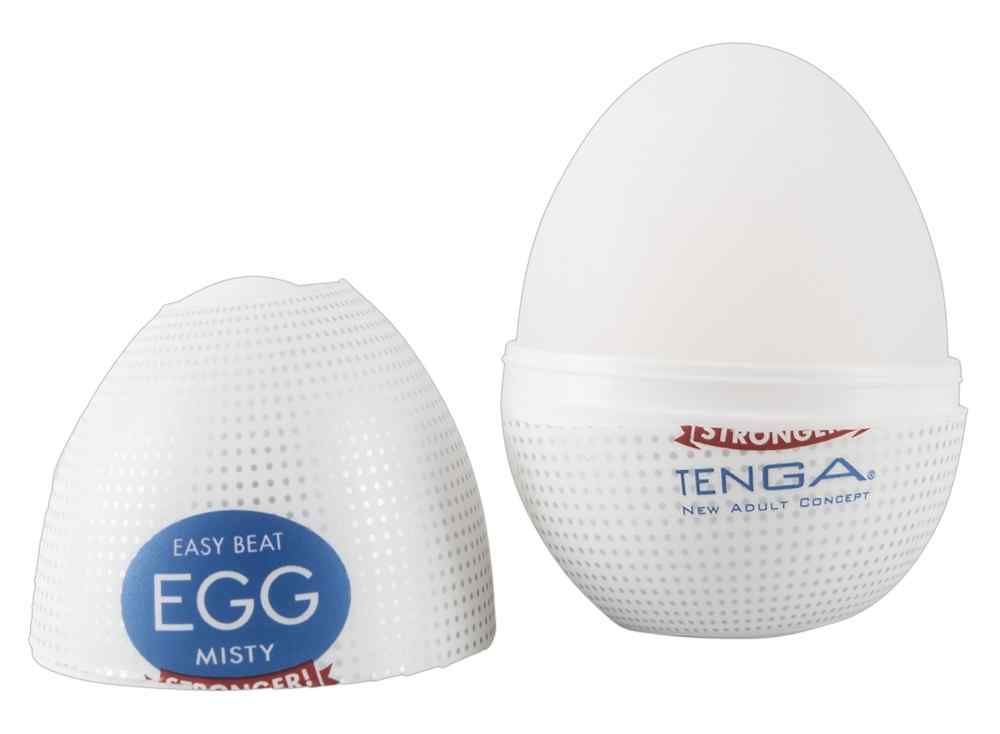 Weißes, eiförmiges Produkt, teilweise geöffnet. Auf der Verpackung steht "TENGA" und "EGG MISTY".
