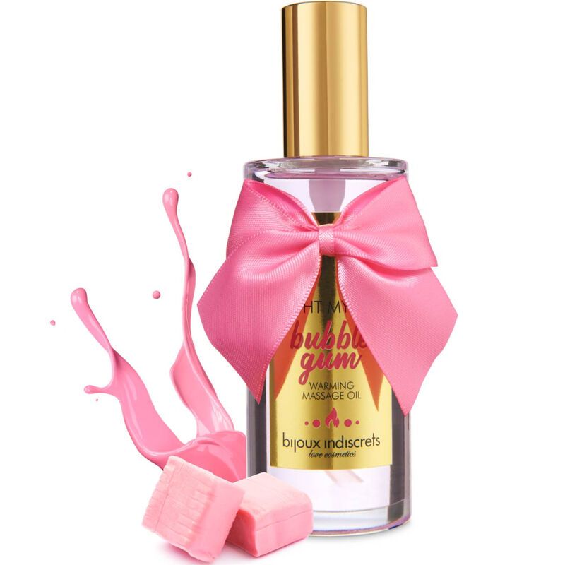 Massageölflasche mit rosa Schleife, daneben rosa Kaugummi-Stücke und Flüssigkeitsspritzer.