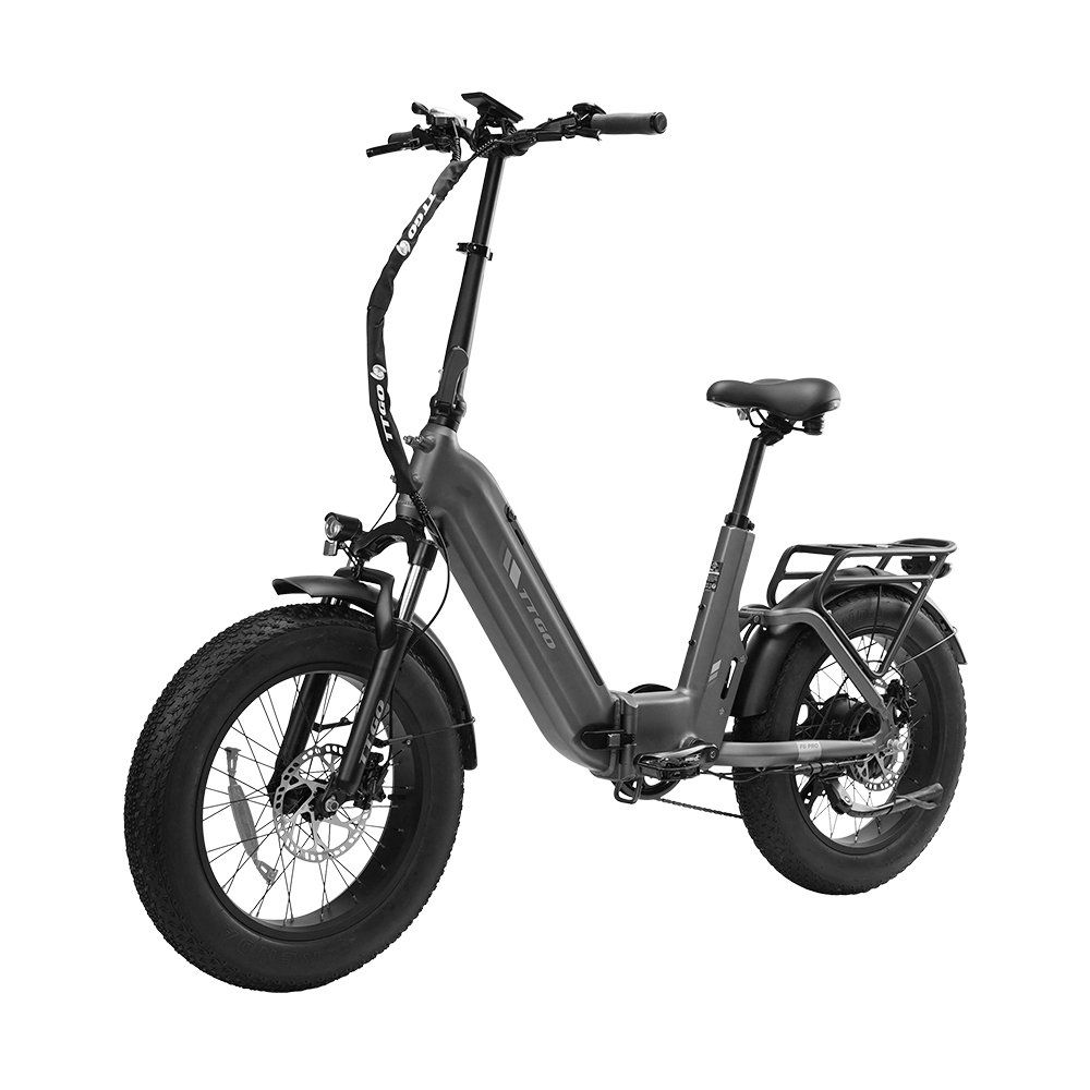 Graues Klapp-E-Bike mit schwarzen Reifen und orangefarbenen Akzenten. Das Fahrrad hat einen Gepäckträger und hydraulische Scheibenbremsen.
