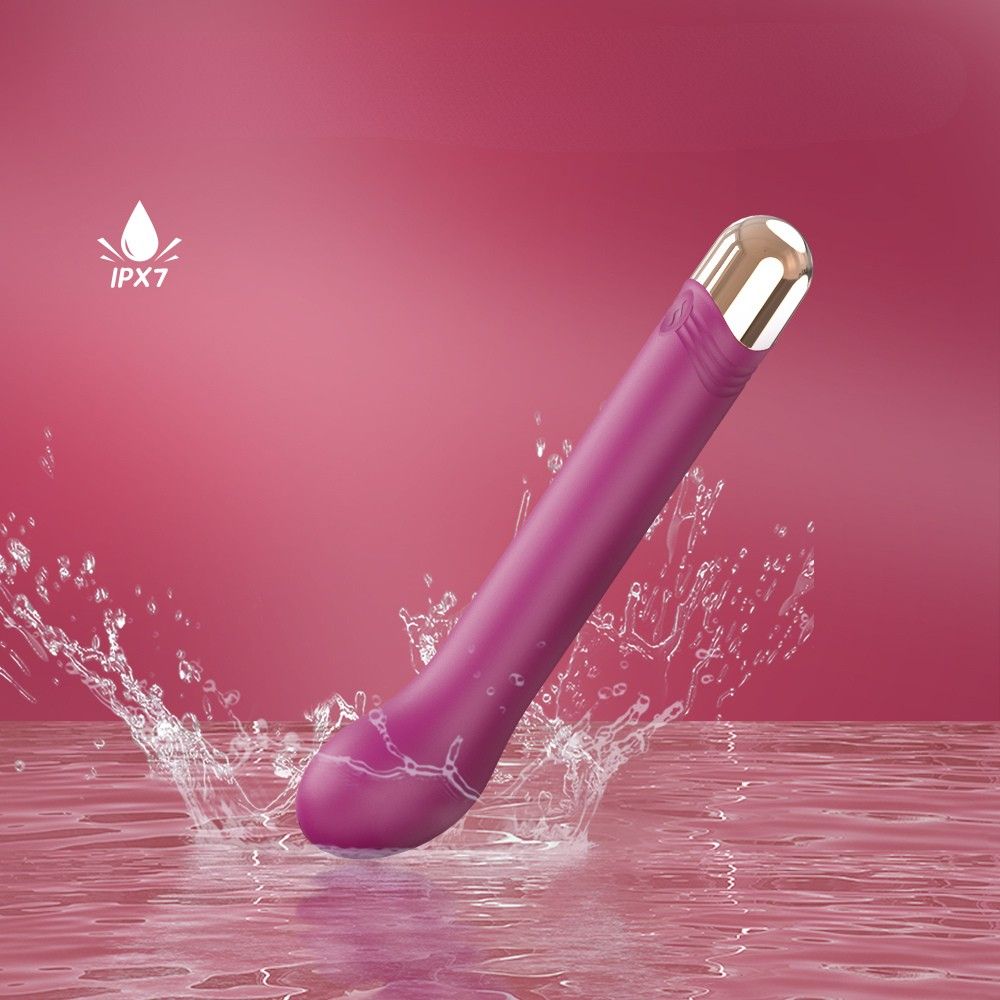 Lila Vibrator mit goldfarbener Spitze. Wasserspritzer. Text: IPX7. Auf rosa Hintergrund.
