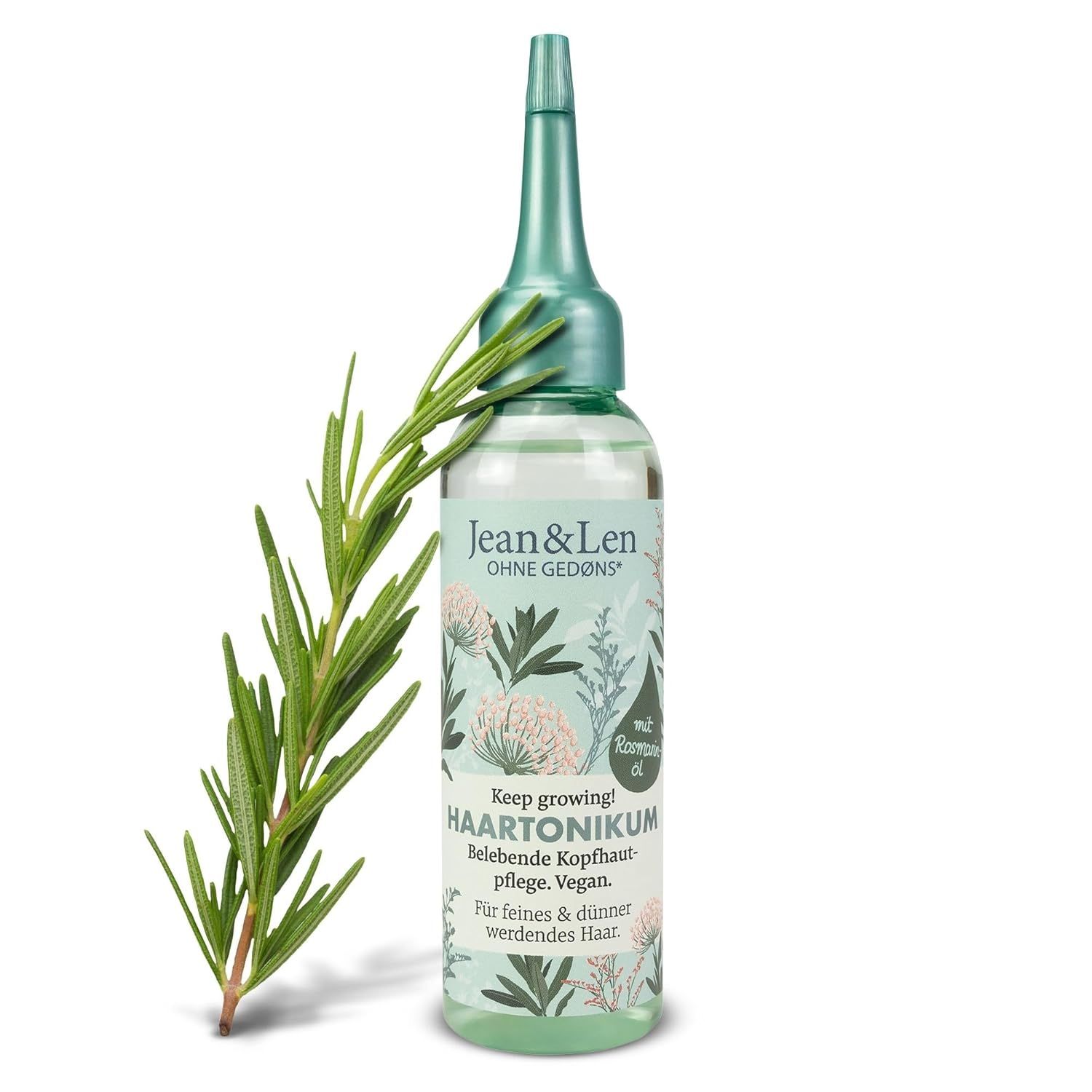 Haartonikum-Flasche mit Rosmarinzweig. Flasche mit grünem Deckel und Etikett. Text: Haartonikum, Rosmarinöl, Vegan.