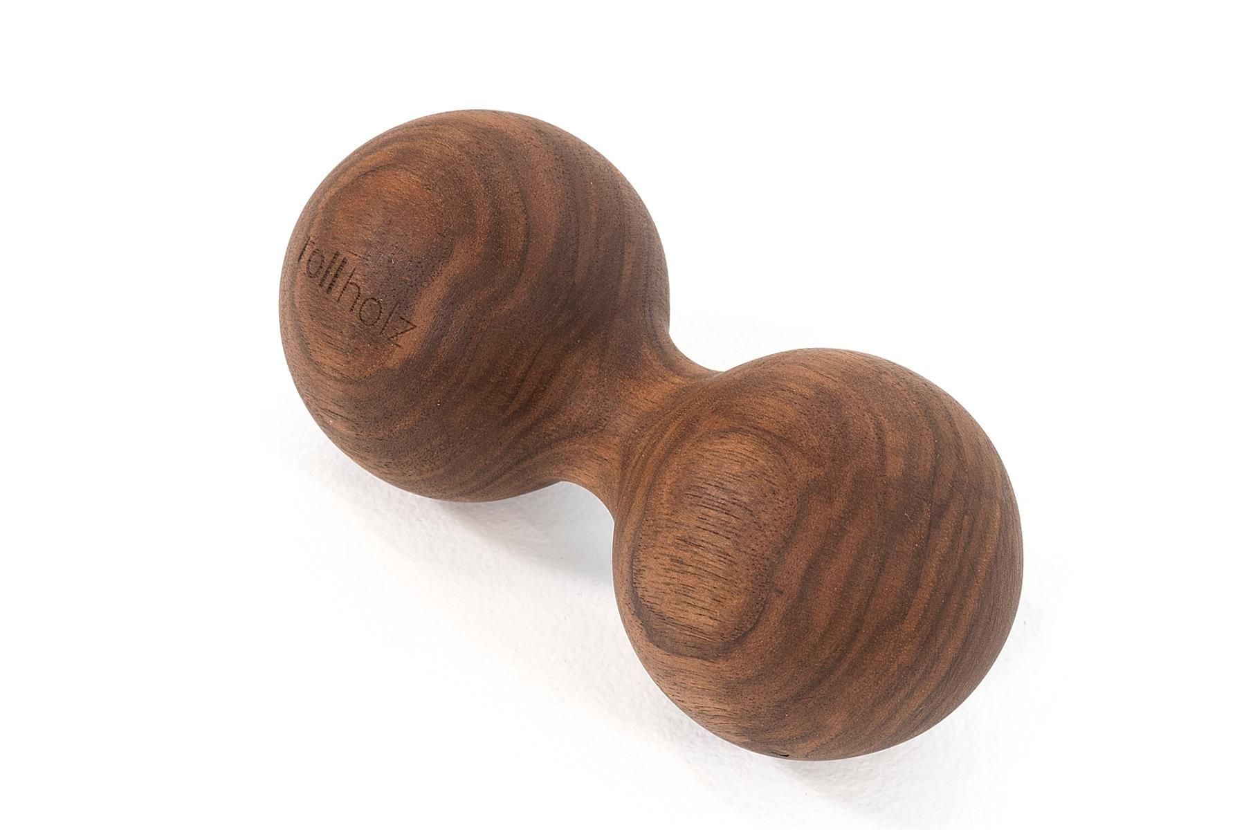 Doppelkugel aus Walnussholz. Zwei Kugeln, verbunden durch einen Steg. Aufschrift 'rollholz'.