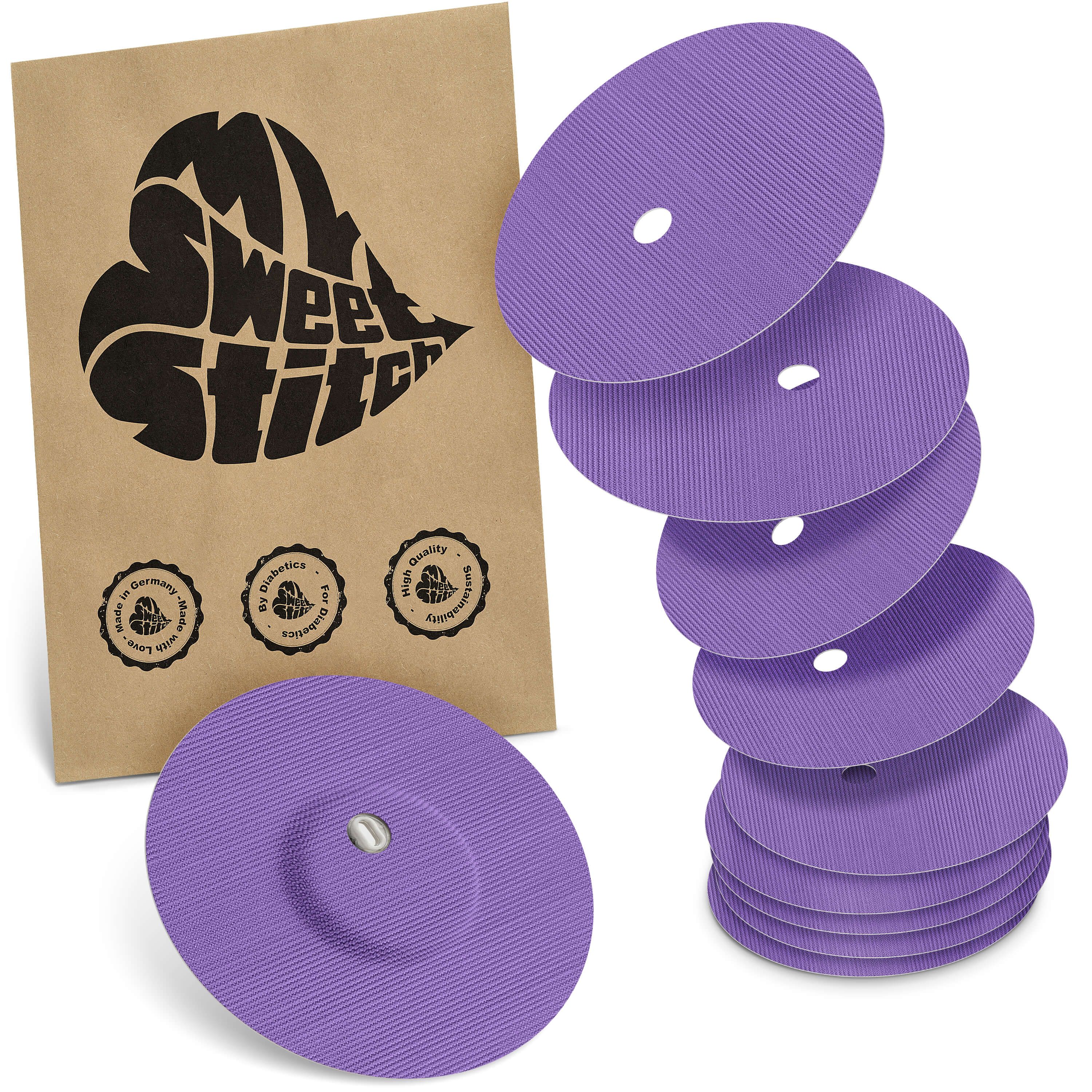 Sechs lilafarbene, runde Pflaster mit Belüftungsloch. Braune Verpackung mit Logo und Siegeln.