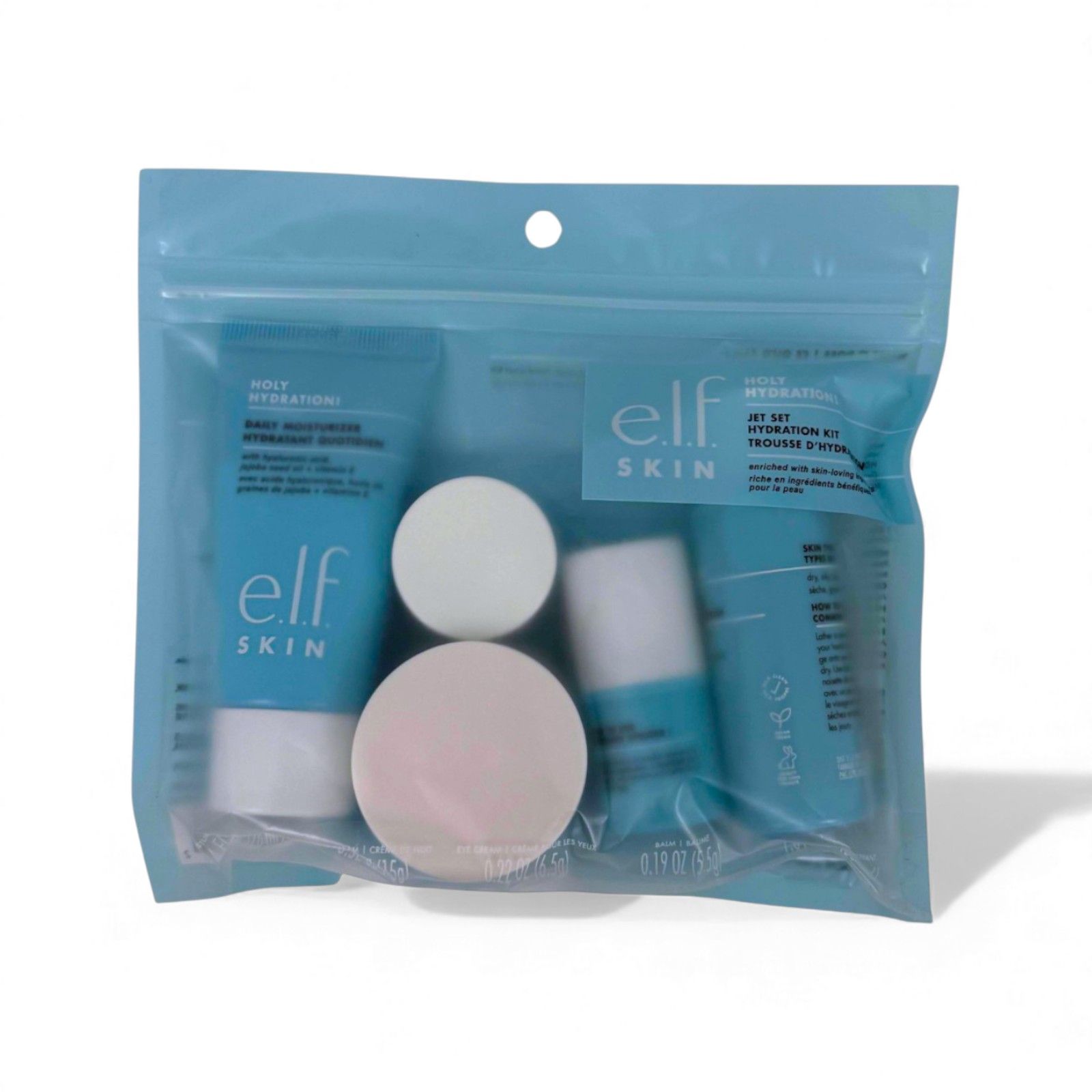 Kosmetik-Set in einer transparenten Plastiktüte. Enthält blaue Tuben, Tiegel und einen Schwamm. Aufschrift: e.l.f. SKIN.