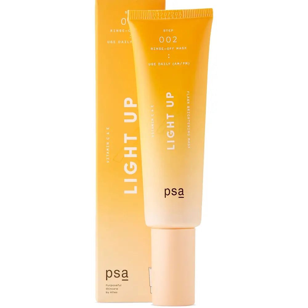 PSA Light Up aufhellende Vitamin-C-Maske neben ihrer orangefarbenen Verpackung.