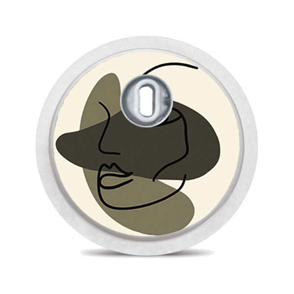 Runder Aufkleber mit abstraktem Gesicht in Beige, Grün und Schwarz. Mit silbernem Mittelteil.