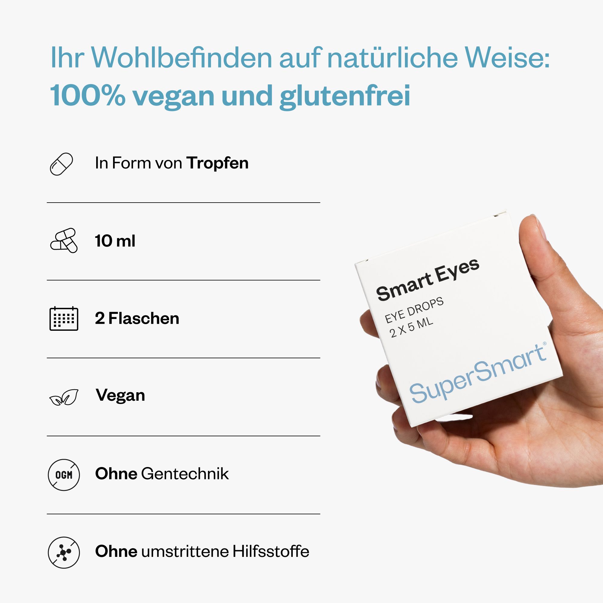 Hand hält eine Smart Eyes Augentropfen-Verpackung. 100% vegan und glutenfrei. 10 ml, 2 Flaschen. Ohne Gentechnik und umstrittene Hilfsstoffe.