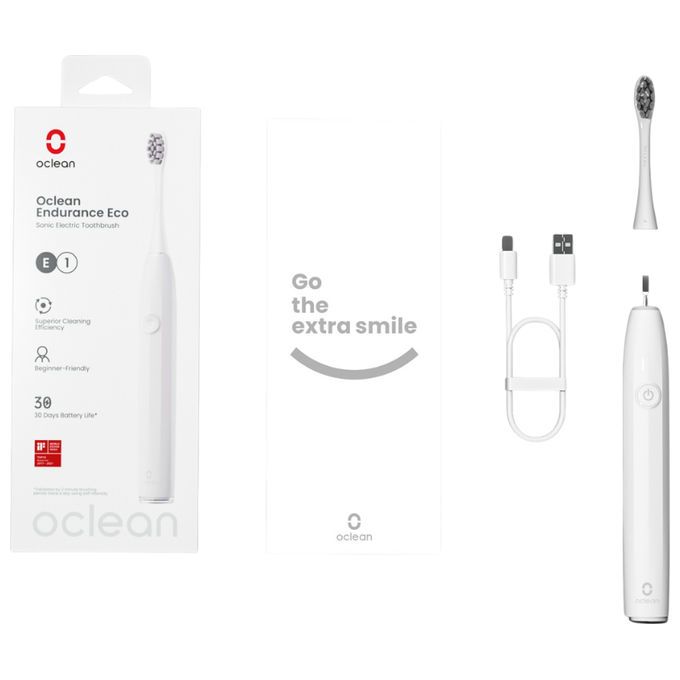 Elektrische Zahnbürste, weiß, mit Zubehör: Bürstenkopf, Ladekabel. Verpackung mit Produktname und Logo.