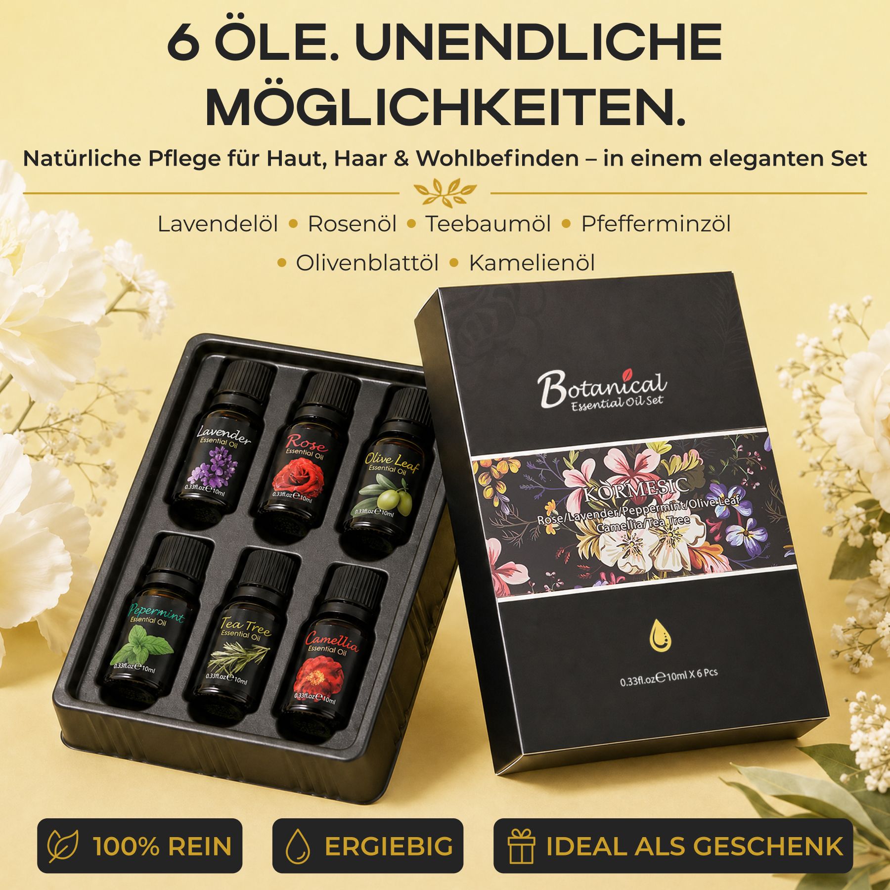 Sechs kleine schwarze Flaschen mit ätherischen Ölen in einer schwarzen Schale, daneben eine schwarze Geschenkbox mit Blumenmuster.